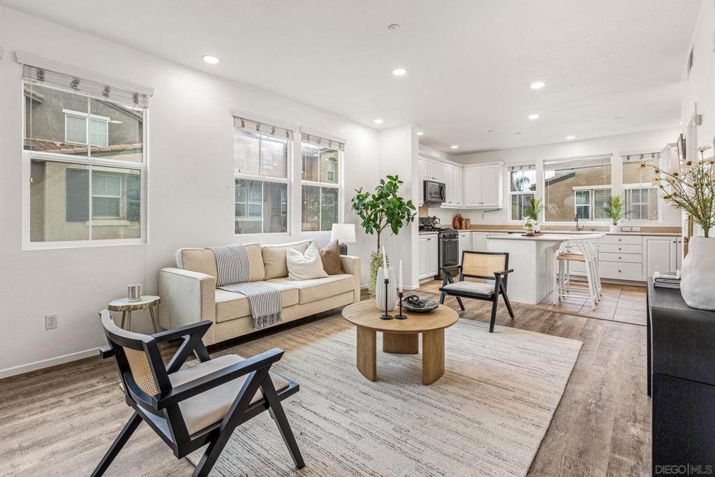 Beautiful, assumable, end-unit townhome in the gated Morningside community of Santee! This light-filled three-story home offers a bright and open floor plan with luxury vinyl plank flooring and a spacious kitchen featuring a large center island—perfect for cooking and entertaining. Enjoy your own private balcony, ideal for relaxing outdoors. The thoughtfully designed layout includes an attached two-car garage, laundry, and entry on the ground floor; an open-concept living area with a half bath on the second level; and two generously sized bedrooms on the top floor, each with its own full bathroom. The primary suite offers comfort and privacy with ample closet space. Additional features include a highly sought-after double-sided garage with separate entrances and extra storage. The Morningside community offers resort-style amenities including a pool, spa, BBQ area, and playground. Conveniently located close to shopping, schools, and with easy freeway access—plus, the complex is FHA and VA approved. This is a home you won’t want to miss!