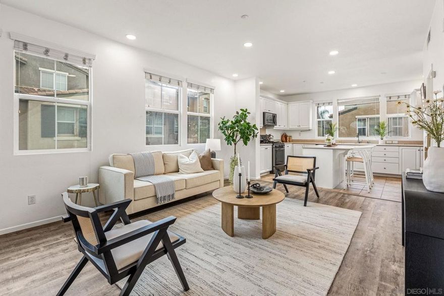 Beautiful, assumable, end-unit townhome in the gated Morningside community of Santee! This light-filled three-story home offers a bright and open floor plan with luxury vinyl plank flooring and a spacious kitchen featuring a large center island—perfect for cooking and entertaining. Enjoy your own private balcony, ideal for relaxing outdoors.  The thoughtfully designed layout includes an attached two-car garage, laundry, and entry on the ground floor; an open-concept living area with a half bath on the second level; and two generously sized bedrooms on the top floor, each with its own full bathroom. The primary suite offers comfort and privacy with ample closet space.  Additional features include a highly sought-after double-sided garage with separate entrances and extra storage. The Morningside community offers resort-style amenities including a pool, spa, BBQ area, and playground. Conveniently located close to shopping, schools, and with easy freeway access—plus, the complex is FHA and VA approved. This is a home you won’t want to miss!