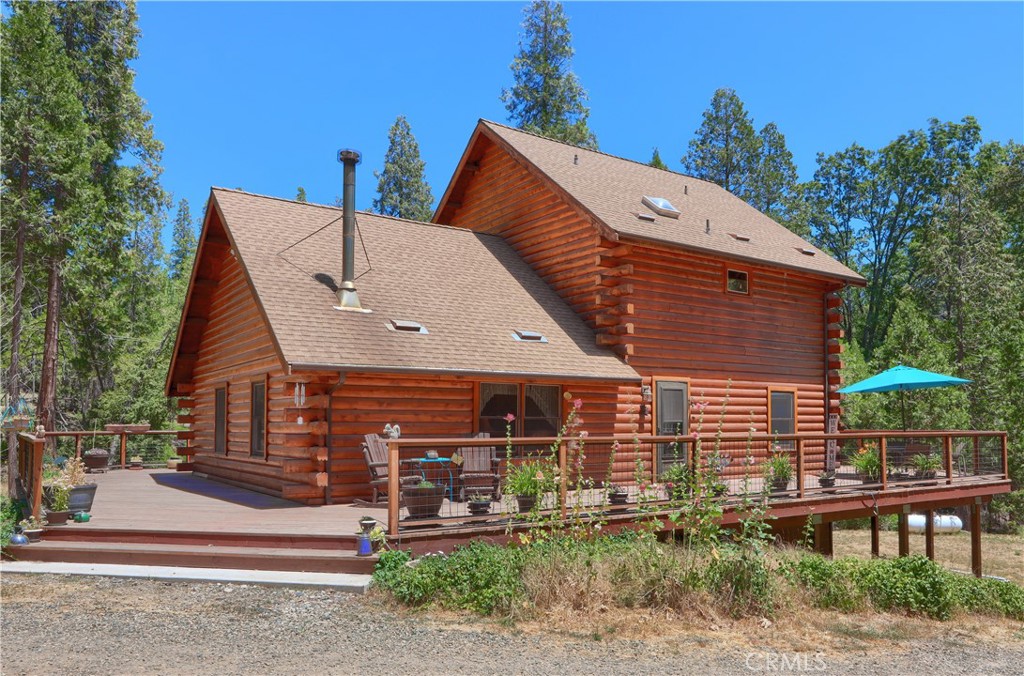 STORYBOOK LOG HOME NEAR YOSEMITE! This picturesque 3-bed, 2-bath Lincoln Log Home is the mountain retreat you’ve been dreaming of—nestled on 5.09 usable acres just minutes from Yosemite National Park and several pristine lakes. Ride, hike, or explore for miles directly from your own backyard with endless trails weaving through the surrounding Sierra National Forest just steps away!
Crafted with care and intention, this 1,904 sq.ft. log home was built in 1987 and lovingly maintained by the original owners who first fell in love with the land during the famed Mariposa Endurance horse rides. Designed for those who crave adventure, freedom, and tranquility, the property offers a three-stall barn with turnouts, cross-fencing, a round pen, and fenced paddocks—perfect for horses, bikes, or off-road toys.
Enjoy sweeping views from the wraparound 2,016 sq.ft. deck, ideal for watching wildlife or sipping your morning coffee as horses and wildlife graze nearby. Inside, the home features an open layout with vaulted ceilings, oak flooring, skylights, and a stone-set wood stove for cozy evenings. The well-equipped kitchen opens to a spacious dining and living area with Sierra national views all around.
Extras include a detached 600+ sq.ft. garage with workshop, a walk-in 560 sq.ft. basement for storage or projects, a private well and septic, a Generac standby Generator, and separate propane tanks for home and backup systems.
Whether you're seeking a peaceful full-time residence, vacation basecamp, or equestrian escape, this one-of-a-kind log home delivers charm, history, and adventure in equal measure. Experience mountain living at its finest—where every ride begins right at your front gate.