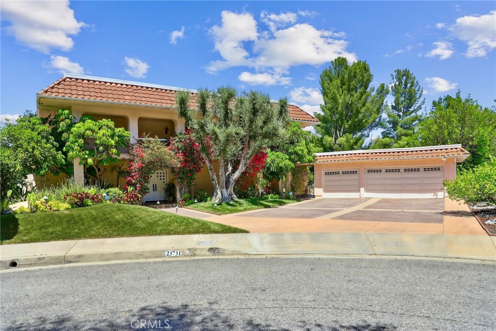Welcome to this beautifully furnished and fully equipped 4-bedroom, 3.5-bath retreat, tucked away at the end of a cul-de-sac in the heart of Calabasas. Offering total privacy, upscale finishes, and a seamless indoor-outdoor lifestyle. Inside, the thoughtfully designed layout features warm wood flooring, curated furnishings, and an abundance of natural light. The cozy living room and formal dining area exude warmth and charm, while the gourmet kitchen features rich wood cabinetry, Spanish tile floors, a large center island, and scenic views of the lush backyard. The spacious primary suite is the only bedroom upstairs, creating a private sanctuary complete with a spa-inspired ensuite, walk-in closet, and access to a generous rooftop patio as well as a large flex space currently utilized as an office and a gym, ideal for working from home. Gym is equipment included optionally. Downstairs, you’ll find three additional bedrooms, each tastefully furnished for comfort and versatility. Step outside to your beautifully landscaped yard featuring a sparkling pool, lush greenery, large deck and multiple lounge areas designed for both quiet mornings and lively gatherings. Additional features include a Ring doorbell, security system, electric vehicle charger, and a 1-car garage with ample driveway parking. Situated in the coveted Calabasas Park neighborhood, you’ll enjoy access to community amenities including the lake and proximity to The Commons, top-rated schools, and great restaurants. This turnkey retreat delivers comfort, privacy, and classic California living at its finest.