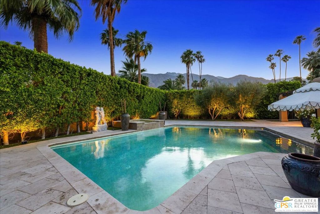 Once the glamorous escape for legends like Frank Sinatra, Marilyn Monroe, Bob Hope, and Cary Grant, The Movie Colony, known affectionately as TMC, remains one of Palm Springs' most sophisticated, sought-after, and architecturally celebrated neighborhoods. Ideally situated just blocks from both the vibrant Design District and the heart of downtown, this exclusive enclave is prized for its rare combination of pedigree, privacy, and proximity. Lined with palm-shaded streets and iconic estates, TMC places you steps from Palm Springs' finest offerings in art, culture, cuisine, and wellness. Dine alfresco at several Michelin Star restaurants, sip espresso at local cafs overlooking the San Jacinto mountains, or explore the galleries and curated boutiques that define the Uptown aesthetic. Beyond the gates, enjoy access to Ruth Hardy Park, stylish wine bars, the Palm Springs Art Museum, the lively Street Art Fair, and more, all within a short stroll. For those who value heritage, design, and lifestyle, TMC delivers a living experience that is as exclusive as it is inspiring. This exceptional estate was crafted for seamless indoor-outdoor living, starting with a premium south-facing backyard that guarantees winter sunshine and showcases unobstructed Mt. San Jacinto views. The resort-style saline pool, elevated spa, and shaded alfresco dining patio are surrounded by lush landscaping, offering total privacy and tranquility. Inside, the formal living room features a sculptural fireplace and custom built-ins, flowing into a chic dining area and a bespoke wet bar. The show-stopping chef's kitchen centers around a French CornuF range, with high-end appliances, tailored cabinetry, and direct access to the outdoors through multiple sets of French and sliding doors. Four well-separated bedrooms ensure privacy and comfort. The luxe Primary Suite includes a 2nd fireplace, stunning views, spa-like bath, and a custom walk-in closet. The Junior Suite has its own entrance and office/lounge area, while the 3RD bedroom opens to the pool with a bath that also serves as a poolside powder. The 4TH bedroom, currently a media room, adds flexibility for guests or creative use. Additional highlights include an attached two-car garage, inside laundry room, a gated motor court, recently upgraded systems including a new roof. This property is also eligible for both short- and long-term vacation rentals, making it a smart investment in one of Palm Springs' most iconic neighborhoods. With around 170 homes only, TMC offers a discreet and tightly knit community, rich in history and wrapped in elegance. This is a rare opportunity to own a private resort in one of Palm Springs' most illustrious neighborhoods. YOU OWN THE LAND. NO HOA FEES. PROPERTY IS UNFURNISHED.