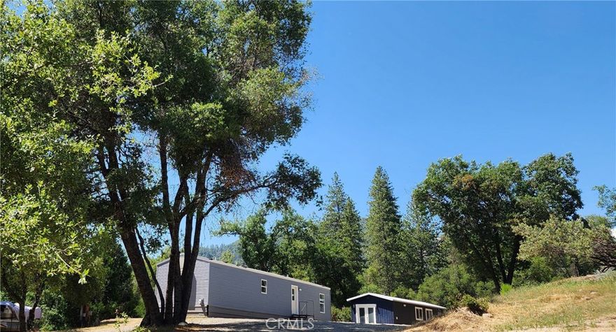 2 homes and a detached suite. This quiet 2.08+/- acre property has 2 manufactured homes, both on permanent foundations and each with their own address, entrance, septic systems and power. Both homes were built in 2017 and have 2 x 6 walls, 40 pound snow load, fire sprinklers, and central air and heat.

The main house is 840 ft, 3 bedrooms, 2 baths with granite counters in the kitchen, new stainless dishwasher, range, and over the range microwave. The interior has recently been painted and both bathrooms have been renovated.

10 feet away is a bonus 400+ ft remodeled suite with a full bathroom and kitchen. Wood Plank tiles throughout, granite/marble in the kitchen and bathroom, mini split, W/D hook ups and a Rinnai tankless water heater.

The ADU is a 742 ft 2 bedroom, 1 bathroom. The interior has been freshly painted and the bathroom has been renovated. There is a 5,000 gallon water tank and RV parking and hook ups.

The 2 houses are close enough to walk to, but separate enough to not feel intrusive.

This property is 4 miles to Bass Lake and is perfect for generational living or for someone looking to live in one house and rent out the 2nd home.