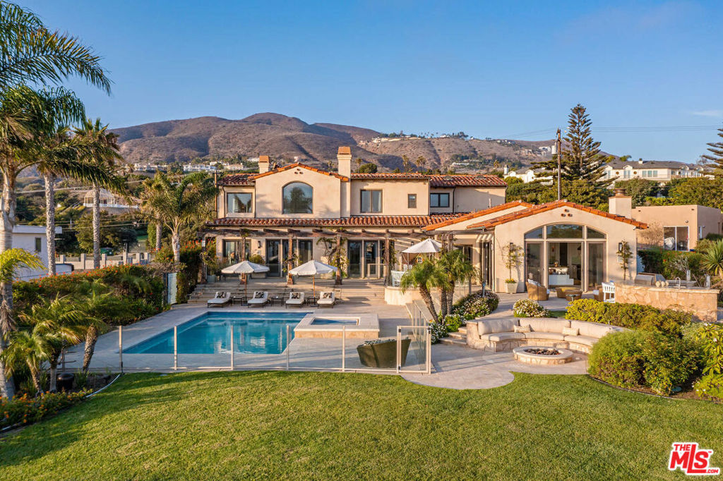 Experience unparalleled seaside luxury in this contemporary Mediterranean estate in one of Malibu's finest neighborhoods. Step inside to find panoramic ocean views as well as a bevy of custom features including crystal chandeliers, travertine flooring, plush carpeting, and soaring coved and tray ceilings. The open entertainer's kitchen is ideal for hosting soirees and features a seated island, top tier-appliances, and opens to the immaculate grounds. The tranquil, oversized master suite includes "his and hers" walk-in closets, bath with soaking tub, steam shower, fireplace, and private ocean-view deck. 5 en-suite bedrooms provide plenty of privacy, while the gym, media room, and game room offer additional lifestyle options. Outside you'll find manicured grounds with pool and spa, sport court, fire pit and outdoor bar and BBQ area. Located just minutes from world-class beaches, dining, and entertainment, this beautiful home is an ideal blend of modern luxury and coastal grandeur.