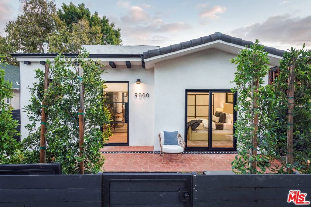 Re-imagined Spanish Modern in the highly desirable Norma Triangle, this one-of-a-kind 2Bd/2.5Ba home with a permitted ADU (complete with kitchenette and full bath) redefines contemporary California living. Clean, sleek, and innovative materials create a light, bright, and airy interior with beautiful hardwood floors and a seamless flow to private outdoor decks. The stylish and state-of-the-art kitchen boasts quartz stone counters, a porcelain slab island, Bosch stainless steel appliances, and custom cabinetry, including a built-in wine fridge. The living area is perfect for entertaining, while the primary suite offers a retreat with a walk-in closet, luxurious bath featuring double sinks and black limestone tile, and a wall of glass opening to a private back deck. A second bedroom wing ensures privacy with its own luxury bath and patio access.The backyard is designed for indoor/outdoor entertaining, complete with custom decks and a built-in BBQ. Additional features include a gated driveway with space for up to 3 cars and drought-tolerant landscaping. Located in a prime West Hollywood neighborhood, this chic and timeless home offers modern living at its finest.