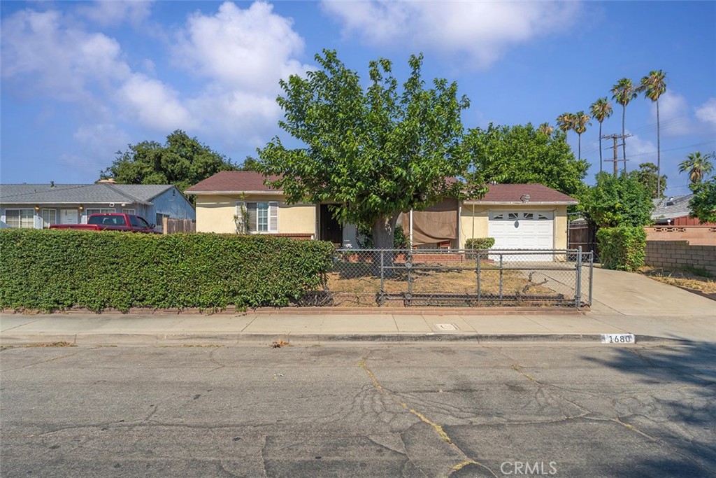 Excellent opportunity to own on South Palomares Street this summer season. Located in a quiet neighborhood near the main entrance of Pomona Cemetary off of Franklin Avenue. This property offers a fenced off front yard accompanied with a privacy hedge and a sloped driveway that greets automobiles at the entry. An attached single car garage is featured with a washer and dryer hook up available. Moreover, the backyard is a dog owners' delight and able to accommodate multiple pets. The backyard has multiple uses to be tailored by the new owner to-be. The foundation is elevated, making maintenance easily accessible and convenient. Inside, two bedrooms compliment a living room and kitchen. A pocket door separates and cancels noise from kitchen to living room that creates a more private setting for both sides. Notable location near is the illustrious and greatly acclaimed Samos Hamburgers. As well as the Pomona Cemetary, Pomona DMV and Daniel's Dry Cleaners. This location is prime due to its access direct route north to Interstate-10 freeway. Similarly, Franklin seamlessly runs east into San Bernardino County and into the city of Chino.