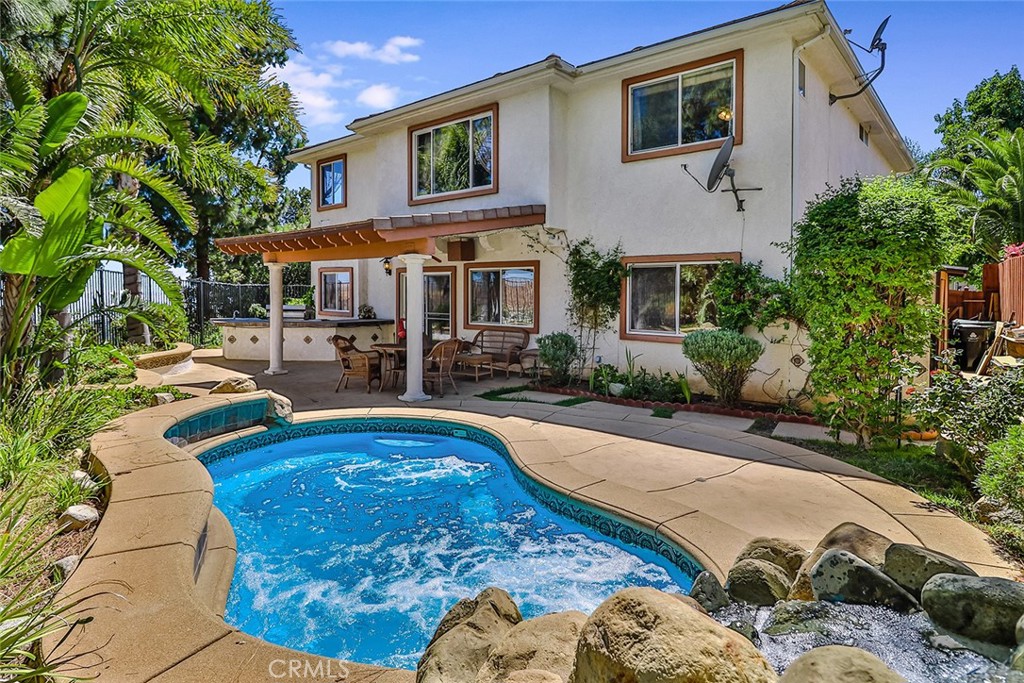 VEW & LOCATION. HARD TO FIND ONE LIKE THIS ONE! Built in 2001 this is one of the NEWEST home in the area, Nestled atop the hills in the exclusive gated community of The Summit at MOUNTAIN VIEW ESTATES, this stunning two-story residence offers BREATHTAKING PANORAMIC VIEWS of city lights, mountains, and hang gliders. Boasting superb curb appeal and pride of ownership, the home features a custom-designed yard perfect for entertaining. Enjoy midnight swims in the spool with waterfalls, dine on the patio, and cook outdoors with the built-in BBQ. The owner has also planted numerous fruit-producing trees and garden boxes, enhancing the property's charm.
Inside, the home is absolutely beautiful, spacious, and turnkey, offering every amenity for enchanted and majestic California living. The large, airy master bedroom features a spa tub, granite counters, double sinks, and an adjacent walk-in closet. The huge formal living room boasts a high ceiling, granite gas fireplace, and glass chandelier. The kitchen, with granite countertops and backsplash, leads into a large family room. A comfortable and cozy second-floor landing with skylights adds to the home's appeal. Additional features include central air, crown molding throughout, interior painting, room lighting, ceiling fans in almost every room, an indoor washroom with entry to the garage, and a uniquely designed backyard with a covered patio, custom tile pool with comfortable seating, six massaging jets, and a tranquil rock waterfall with night lighting. The built-in BBQ area includes a tile countertop, sink, and refrigerator. Beautiful landscaping features Mother Queen Palm trees and large concrete tile steps. The huge two-car garage offers an electric door, mirrored wall, and ample custom closet and storage space, along with a security system.