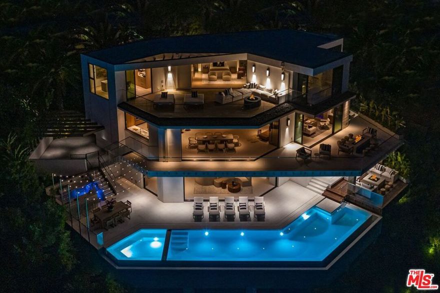 A warm organic modern estate designed by Disco Volante. Standing regally at the end of a cul-de-sac on one of the best promontories in Beverly Hills with unobstructed views of the entire city from DTLA to the ocean. Minutes away from The Beverly Hills Hotel & Rodeo Drive. Breathe California in this ultra-luxurious, 3-story modern with open floor plan & wall-to-wall sliders providing the quintessential SoCal indoor-outdoor lifestyle. A luxurious master suite includes an oversized balcony, walk-in closet & soaking tub surrounded by retractable doors. Lower level entertainer's paradise includes a home theater, custom bar, outdoor kitchen, firepit lounge & infinity pool. Architecture by the Dutch design masters at Unknown, every square inch was crafted to perfection using only top-of-the-line materials sourced from around the world. A truly magnificent offering & exclusive opportunity to own an estate of modern elegance in the most prestigious zip code in the world.