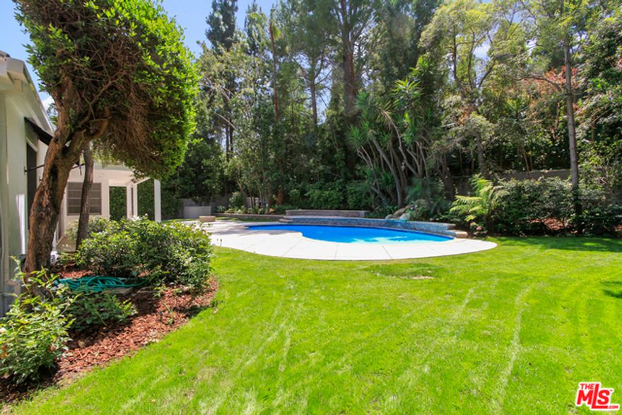 Charming one level storybook traditional on prime lower Laurel Way. North of Sunset, a few blocks from the Beverly Hills Hotel, this reimagined jewel box is perfection. Open floor plan boasts elegant living room with fireplace, family room and formal dining room, drenched in sunlight. Glass sliders open to incredible flat backyard with waterfall pool, outdoor dining area and fire pit. Chef's kitchen has breakfast area bathed in sunlight with views of the backyard. Three bedrooms, including generous master, all en suite. Master has tremendous closet, additional sitting area, and exquisite master bath. Additional two bedrooms also have great closets. This is a perfect opportunity to live on one of the best streets in Beverly Hills for an amazing price!