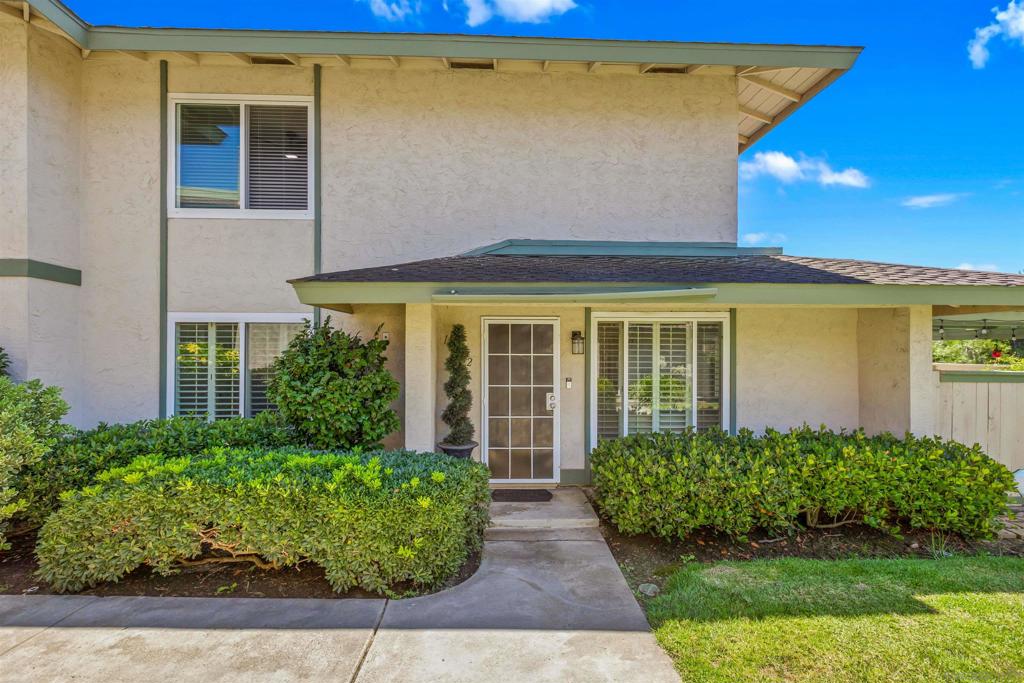 Welcome to this stunning townhome in the highly sought-after Quest Complex of Mira Mesa! Enjoy a premium, quiet location tucked away in the back corner of the community, surrounded by lush greenbelt views. Inside, the open-concept floor plan is enhanced with an A/C system, fresh interior paint, new carpeting, plantation shutters, designer lighting, and luxury vinyl plank flooring. The kitchen features crisp white cabinetry, Corian countertops, and convenient bar seating, while the spacious living room with a cozy fireplace flows seamlessly into the dining area. A downstairs bedroom and full bathroom offer added flexibility for guests or a home office. Meander outside to an expansive private patio—perfect for entertaining, relaxing, or dining al fresco—complete with a laundry closet for added convenience. Two assigned parking spots are located nearby. The community offers resort-style amenities with two swimming pools, two spas, and beautifully maintained park-like grounds. HOA dues include water, trash, and exterior landscaping. Ideally located close to freeways, Lake Miramar, schools including Miramar College, shopping, and dining—this home truly has it all!