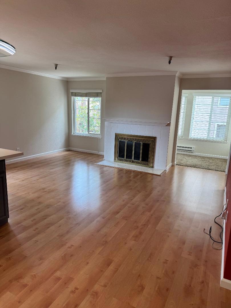 Welcome to this spacious 1-bedroom home located in close proximity to Burlingame Avenue. Spanning 982 square feet, this well-maintained corner residence offers a cozy living environment, thoughtful amanities and an abundance of natural light. Enjoy the comforts of an ample living room connecting to a light-filled sunroom/office and a den for an extra sleeping , work or play space. The updated open kitchen comes fully equipped with modern stainless steel appliances making meal preparation a breeze. The secluded bedroom leads into the updated bathroom with dual sinks and glass shower enclosure. In-unit washer and dryer provides convenience for laundry tasks. An assigned parking space inside the gated common garage is included. Available immediately!