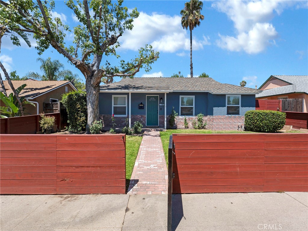 Welcome to this charming Lake Balboa gem — a classic single story 3-bedroom (currently configured as a 2-bedroom), 2-bath home offering 1,234 square feet of living space on a generous 6,002 square foot lot. This gated property boasts a grassy front yard, large rear yard and a detached garage with fully approved plans for an ADU, ready for the new owner to build and maximize the value!
Mid-century design touches blend beautifully with modern upgrades throughout the home. The updated kitchen features stone countertops, a spacious island, and stainless steel appliances — perfect for cooking and entertaining. The cozy living room is centered around a stunning wood-burning fireplace, ideal for creating warm memories, especially during the holidays.
The primary suite and secondary bedroom have been combined to create a sprawling en-suite retreat, offering plenty of space and comfort. Notable system upgrades include a newer presidential-style roof, newer sewer line under the home and out to the street, copper plumbing, central AC/heating, recessed lights, tankless water heater, a convenient service porch off the kitchen with laundry and energy-efficient Milgard dual-pane windows installed in 2019.
Step into the backyard and discover the large parcel with synthetic grass, open space, possible RV access, ample parking and plenty of room to entertain or expand. You’ll also enjoy a bountiful avocado tree along with lime and orange trees — perfect for year-round enjoyment.
All of this in a prime Lake Balboa location, just steps to Saticoy Plaza (featuring Starbucks, Ralphs, Panda Express, El Pollo Loco, The Chop Shop BBQ and Chase Bank), local favorite Humble Bee Cafe, and just a short drive to Lake Balboa Park, the Japanese Garden, Multiple Parks, Encino Farmers Market, Golf courses, Tennis Courts, Archery, the Metro, Ventura Blvd, the 101 and the 405 This home is full of potential, pride of ownership, and possibilities. Don’t miss your chance to make it yours!