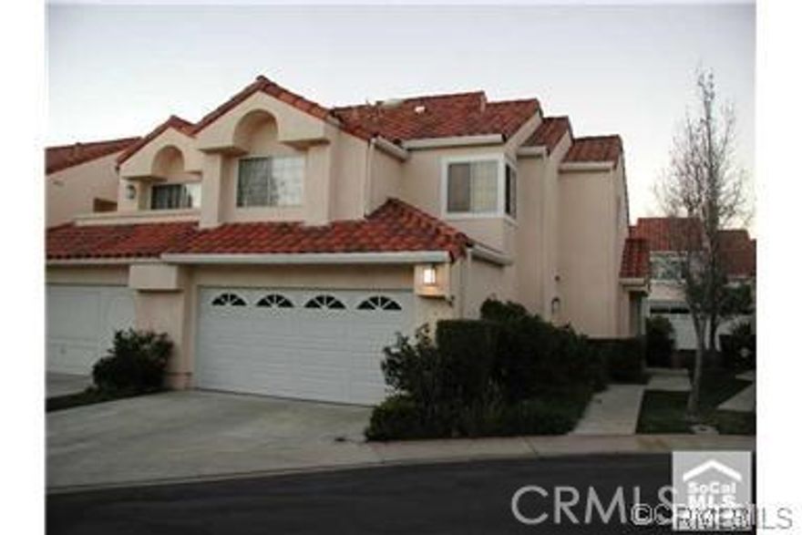 Light bright and roomy townhouse near end of cul-de-sac.  Formal dining area off living room, which features a gas fireplace.  French doors open from living room to patio.  Open kitchen area to family room with custom wood sliding doors that open to covered patio.  Master bedroom has high ceilings and two closets with closet organizers and mirrored sliding doors.  Double vanity in master bath with full bath and shower.  Third room is open and can be used as office or bedroom with built-in oak book case and desk.  Low maintenance, completely enclosed private backyard with flag stone patio and planters.  Great for entertaining!  Direct access two car garage with additional room to park on driveway.  Located in prestigious Niguel Point community with association pool, spa and private tennis courts.  Very close to parks, shops, restaurants and movie theaters.