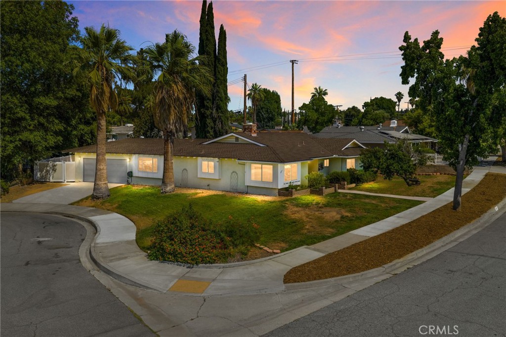 Single story, South Redlands move in ready home with an attached garage and private yard on a quiet, tree lined street. Located just minutes from Gerrards Market, Smiley Elementary and Cope Middle School, this four bedroom, two and a half bath ranch home is comfortable and convenient. Located on the corner of a small cul-de-sac, you enter the home and are greeted by a warm family room with vinyl flooring and a brick fireplace. A spacious dining area is off to your left that leads directly into the updated kitchen with quartz counters, a subway tile backsplash, and stainless appliances. There is a half bath for guests adjacent to indoor laundry, and an opening into the second living area. A large slider opens up to the low maintenance backyard with a sizable covered patio and durable block walls and vinyl fencing. the primary bedroom inside has it's own bathroom, and the additional three bedrooms are serviced by a full bathroom. Dual pane windows help keep the energy costs down. Excellent Redlands Schools.