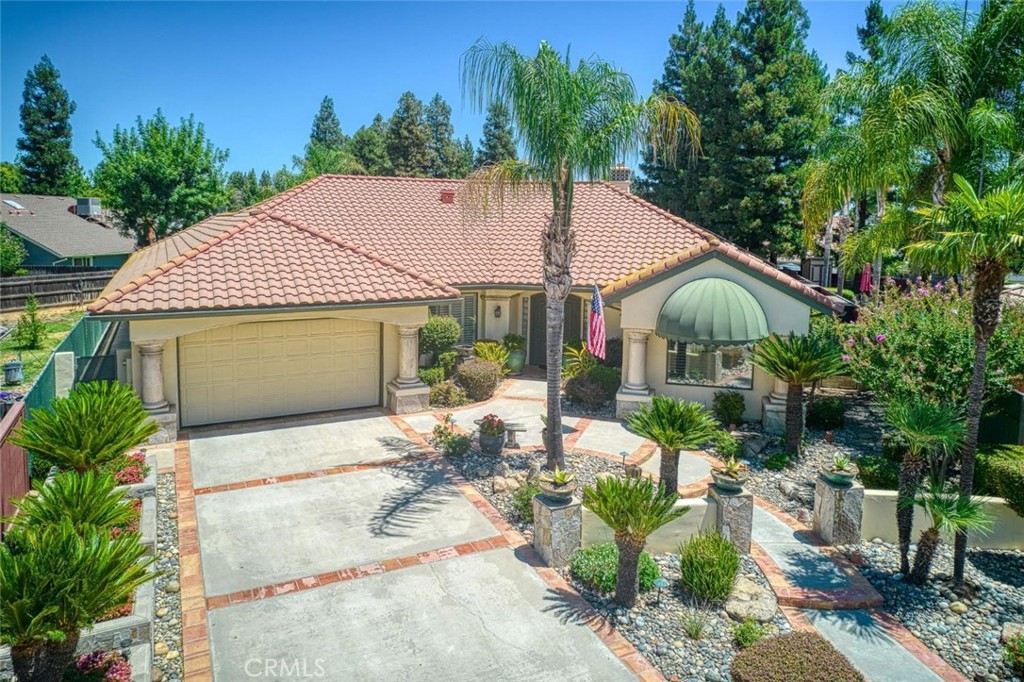 Immaculate and thoughtfully designed, this Early California-style single story home w/OWNED SOLAR offers approx. 3,000 sq. ft. of inviting living space on a ?-acre lot in a prime NE Fresno location. Inside, you'll find 3 bedrooms, along with 3 bathrooms & handcrafted details throughout. High ceilings10 ft. throughout, and up to 15 ft. in the family room & primary bedroom. Finishes include hand-troweled wall texture, crown molding, skylights, recessed lighting (52 total with dimmers), surround sound, and custom built-ins. The main living area centers around a stunning fireplace with gas inlet & heatilator. The home also features two 80-gallon water heaters, 2 A/C units, extra insulation, & dual-pane windows.The fully finished approx. 1,500 sq. ft. garage is a dream space perfect for a car enthusiast, creative studio, or guest suite. It includes reinforced concrete with rebar & an extra inch of depth, water-proof sheetrock, sink with hot/cold water, insulated garage door, A/C units, ceiling fans, built-in TVs, surround sound, storage, & Venetian blinds.Outdoor living is just as dialed in. A 700 sq. ft. covered patio w/surround sound, lighting, & ceiling fan flows into a private backyard with synthetic lawn (professionally installed w/proper drainage), automatic irrigation, mature landscaping, sago palms, sheds, planter beds, & a pergola. Additional features: metal gates, yard lighting, & rain gutters tied to underground drainage.
