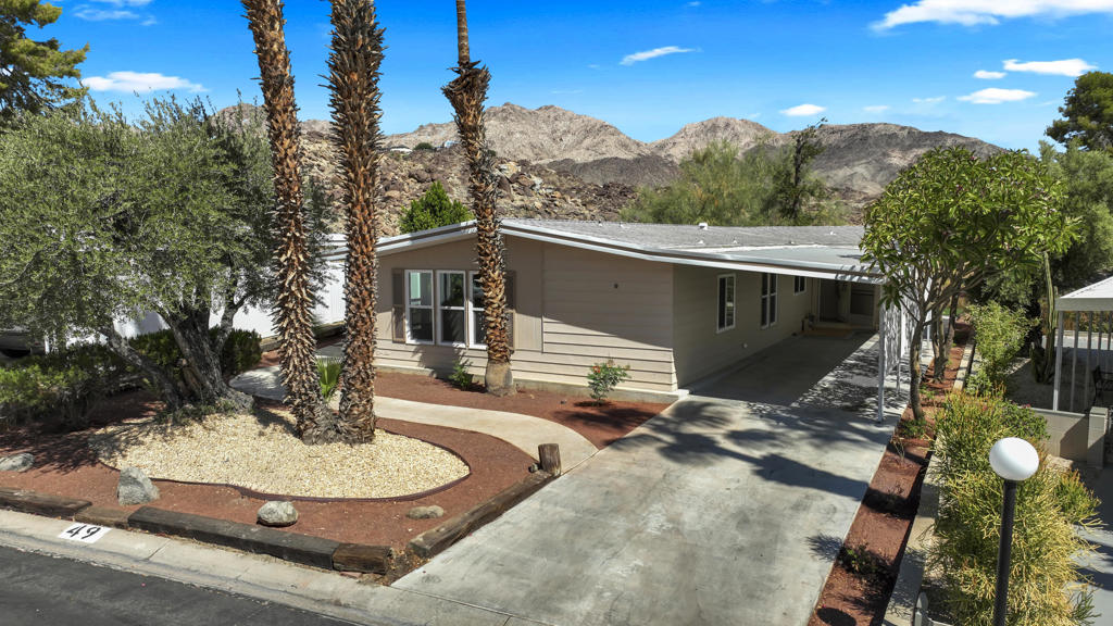 VIEWS/ VIEWS/ VIEWS/ This magnificent one of a kind triple wide home has been completely remodeled and looks like a brand new model home. It is Located on an extra large Lot facing the Beautiful mountains with no odstruction, Patios and Canopies all around the home. Indian Springs Mobiles is a 55+ community with all the amenties of a fine Country Club including ckub house pool and Spa, greenbelts ect and is in close proximity to world famous El Paseo for fine dining shopping and entertainment Dont delay hurrry you do not want to miss this opportunity.Please see re-model detail doc attached for a comprehensive list of the work that has been done.SPC Rent 949.00 per mos