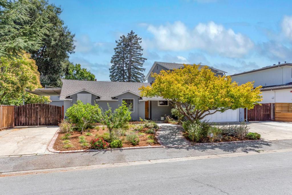 Located in an idyllic neighborhood just moments from acclaimed schools and vibrant downtowns, this classic home offers a flexible two-level floor plan, a detached workshop, and a sparkling pool and spa. Upon entry you are met with a very spacious living room with gorgeous hardwood floors, a pocket door to a convenient office nook, and French doors to the covered patio and the yard. Just next door, the quartz-appointed kitchen enjoys an oversized center island, and sits open to the light-filled dining room with a wide bay window. Three bedrooms including the primary suite are situated quietly on one side of the home, while a bedroom suite encompasses the entire upper-level with an attached office/bonus room, ideal for guests or extended family with a separate side entrance. Outside, paver stone patios and mature landscaping surround the pool and spa, and a covered side yard provides even more outdoor living and entertaining space. In addition to the attached two-car garage, a detached fully-permitted workshop has 220V electrical, water/sewer, a roll-up garage door, and a half bathroom that serves the pool and outdoor area. A home that meets the needs of a modern family lifestyle, with fabulous amenities in both downtown Mountain View and Los Altos, and top-rated schools nearby!