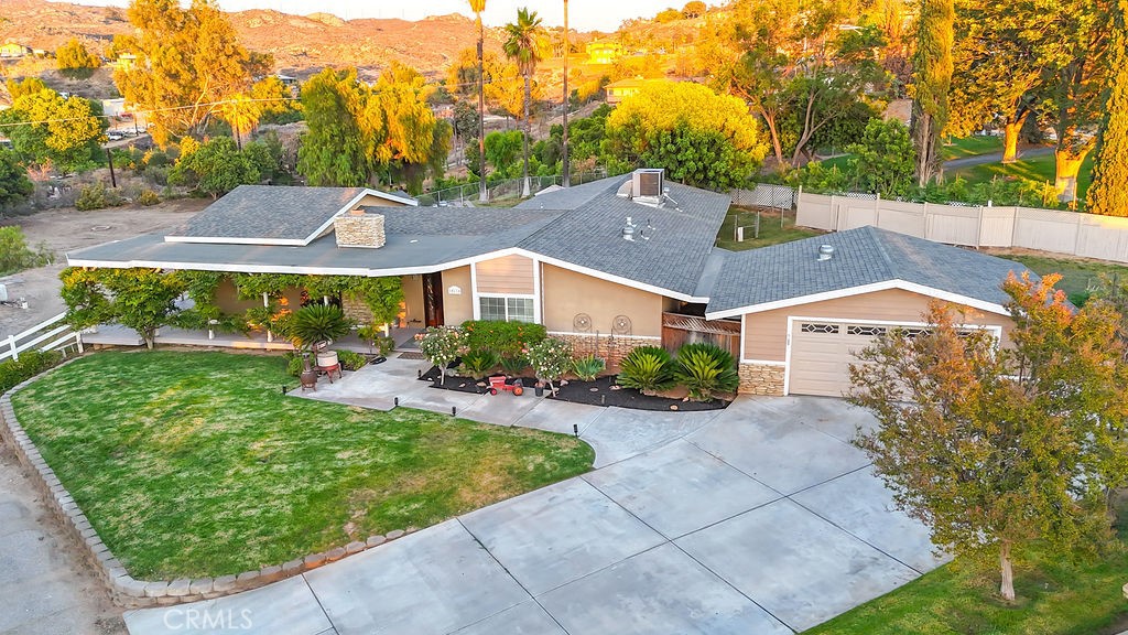 WELCOME HOME!!! Perched atop a scenic hill, this charming single-story ranch offers sweeping views of mountains and rolling hills on just over an acre of fully fenced, usable land. Whether you dream of bringing your horses, storing your toys and vehicles, or planting your own orchard, the possibilities are endless.Step onto the wraparound porch and follow it to the backyard oasis, where you’ll find a sparkling pool and relaxing jacuzzi—perfect for outdoor entertaining. A separate, lush yard with plenty of grass provides a safe and spacious area for kids and pets to play.Inside, you’ll love the newly installed luxury vinyl plank flooring that flows through the main living areas. The expansive open-concept family room features a cozy fireplace and French doors that lead out to the pool area, blending indoor and outdoor living seamlessly.The updated kitchen is a chef’s delight, showcasing beautifully refinished cabinets with under-cabinet lighting and display lighting above—ideal for highlighting special heirlooms. This thoughtful layout includes two primary bedrooms, each with its own ensuite, providing comfort and privacy for guests or multi-generational living. Two additional generously sized bedrooms share a well-appointed hall bathroom.Recent upgrades add peace of mind and modern comfort, including complete home repiping this year, a 4.5-ton AC unit installed within the last two years, stylish new fixtures, and a double-pane slider off the dining room. The property is irrigated with well water, saving significantly on utility bills.Enjoy the tranquility of country living while being just minutes from shopping, restaurants, freeways, and excellent schools. Don’t miss your opportunity to own this versatile retreat—CALL FOR YOUR PRIVATE SHOWING TODAY!!!