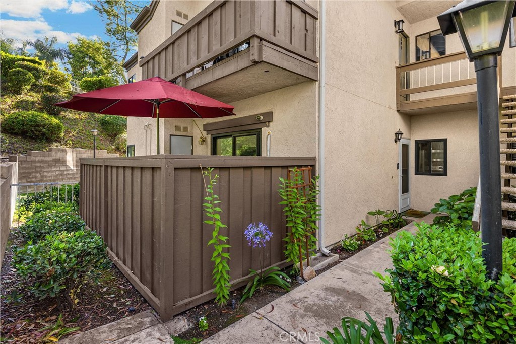 Welcome to 22709 Lakeway Drive #493, a well-maintained end-unit located in the highly sought-after Diamond Bar Tennis Club community. This charming condo features newer interior paint and modern recessed lighting, creating a bright and inviting atmosphere. The spacious living room is enhanced by vaulted ceilings, a cozy fireplace, and a newly installed split AC system, providing comfort and efficiency year-round. The kitchen offers granite countertops, custom wood cabinetry, a tile backsplash, and stainless steel appliances, all seamlessly flowing into the dining area. Both bathrooms have been tastefully updated with walk-in tiled showers, contemporary vanities, and upgraded fixtures. Additional highlights include dual-pane windows, durable wood-look tile flooring throughout, and an in-unit washer and dryer. The unit also includes a one-car garage and a covered carport space. Residents enjoy access to a gated community with 24-hour security, pools, spas, tennis courts, and a clubhouse. Ideally situated near shopping, dining, and freeway access, this home offers comfort, style, and convenience in one of Diamond Bar’s most desirable neighborhoods.