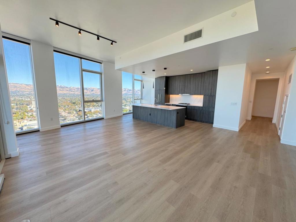 Discover the pinnacle of urban sophistication in this 27th-floor penthouse, offering sweeping city views. Floor-to-ceiling windows flood the space with natural light, while a private balcony invites you to indulge in elevated outdoor moments. The open-concept design seamlessly blends high-end finishes with functionality, featuring a modern kitchen complete with an island, bar seating, abundant storage, wine fridge and premium Miele appliances. The primary suite is a serene retreat, offering ample closet space and a spa-inspired bathroom with heated floors and a calming rain shower. The second bedroom offers plenty of light and gorgeous views. Community amenities redefine luxury, boasting 24/7 concierge service, a resort-style rooftop pool with cabanas and grills, a state-of-the-art fitness center, a bark park, and round-the-clock security. Designer spaces like a private art gallery and breathtaking rooftop views enhance the ambiance. Relax at the Sky Deck fire pits or gather in the private dining suite. Penthouse residents receive complimentary membership to The House - a private social club that affords exclusive experiences such as Chefs Table Dinners & Twilight Tastings. This residence is more than a home; it's a lifestyle, crafted for those who expect the extraordinary.