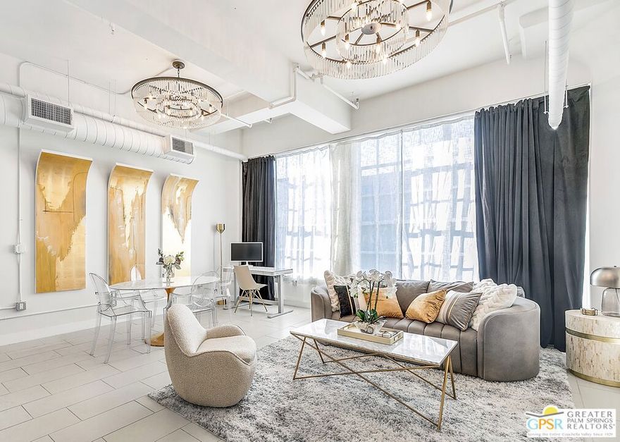 Step into cinematic downtown luxury at 939 S Broadway. This stunning 1-bedroom, 1-bath corner loft glows with light from both the south and west, filling the space with golden afternoon warmth and dramatic sunset views. Framed by ceiling-to-floor plush velvet curtains, the expansive living area is anchored by two grand statement chandeliers, while a three-tier crystal chandelier in the entryway sets an unforgettable tone the moment you arrive. Offered fully furnished, this home is a turnkey designer showcase perfect as a high-performing Airbnb investment or a sophisticated city retreat. Enjoy soaring ceilings, polished concrete floors, and timeless industrial character complemented by resort-style amenities including a rooftop pool and spa, fitness center, and 24-hour security. While the building itself does not include on-site parking, secure parking options are conveniently located directly across the street, making city living both luxurious and effortless. All just steps from DTLA's finest dining, shopping, and entertainment along the vibrant Broadway corridor.