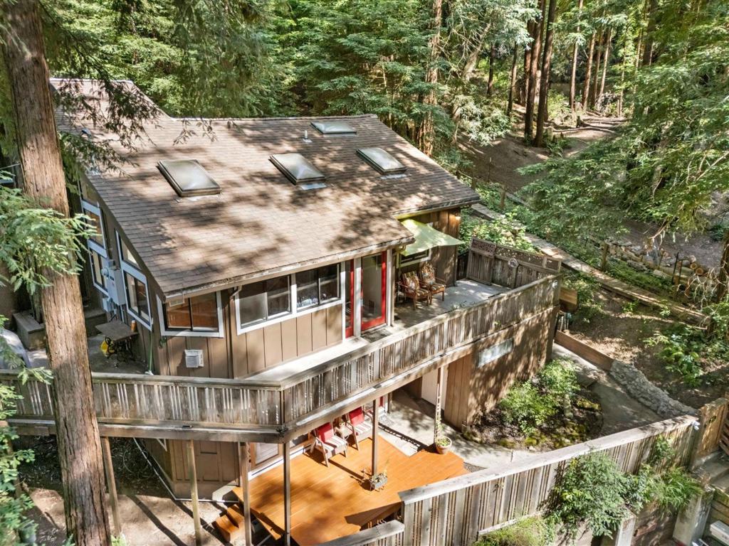 This property is a true redwood retreat - private, peaceful, and turnkey ready. Whether you're looking for a full-time residence or a weekend getaway, 483 Echo Lane delivers the best of mountain living with modern luxury. Amenities include granite countertops, stainless steel appliances, including French-door fridge and built-in microwave, large bay window over the sink offering immersive forest views, recessed and pendant lighting for a bright, inviting workspace, vaulted ceiling with skylights offering natural light and ventilation, custom walk-in shower with glass enclosure and relaxing soaking tub, private deck access and serene views, beautiful engineered hardwood flooring connects each room seamlessly, elevated decks surround the home, nestled among towering redwoods offering both shade and privacy, multi-level terraced yard with ample outdoor living areas, separate studio building great for remote work space, yoga/art studio or bring your imagination, 500 gallon propane tank onsite, washer and dryer in furnace room and main house, stand by generator turns on automatically when there is a black out, collection site for garbage is just down the street from the property, as well as mailbox, 2 parking spots plus additional 3 improved spots directly across from the property.