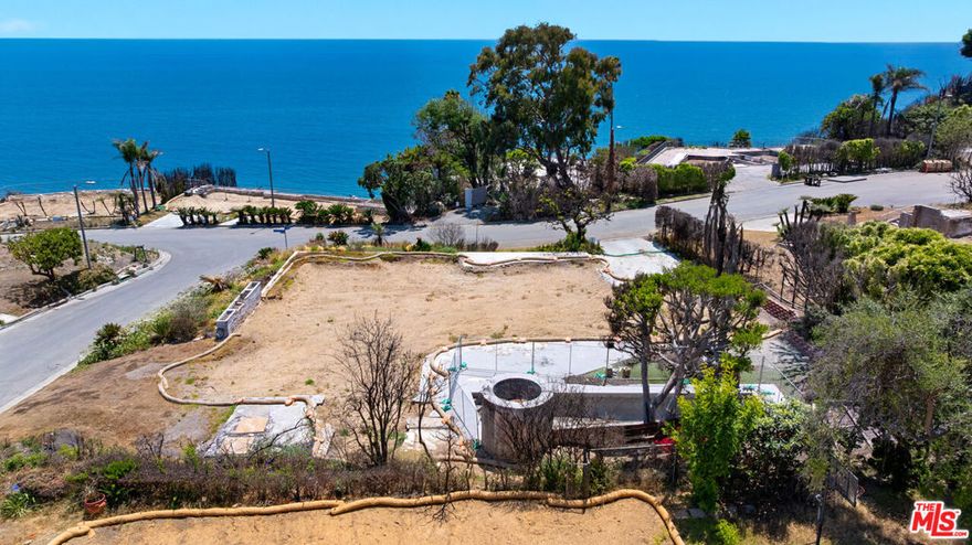 An extraordinary opportunity to build your dream home on a rare, completely flat lot with breathtaking ocean views stretching from the Queen's Necklace down to Palos Verdes and Catalina. Located on the highly desirable Roca Chica Drive, this Palisades fire lot comes with fully submitted plans and expedited permitting that include over a 10% increase in square footage from the original structure. Designed by Malibu Design Center, the proposed single-level modern home spans 4,381 square feet in total including the garage, and features floor-to-ceiling glass throughout to maximize panoramic views and seamlessly embrace its natural surroundings. The layout includes 4 bedrooms, 6.5 bathrooms, and striking architectural elements such as two 18-foot-high pitched ceilings, 12-foot vaulted entry doors, natural wood cladding, and effortless indoor-outdoor flow creating a serene yet sophisticated atmosphere. The open-concept great room offers a seamless flow between the living area with a fireplace, dining space, and chef's kitchen with a center island and oversized walk-in pantry. The primary suite is ideally positioned on the southeast corner to capture sunrise views and includes dual bathrooms and closets. There are two additional guest bedrooms, two dedicated offices, a media room, and an attached 2-car garage. A separate guest suite features a lofted sleeping area, living room, and kitchenette with direct pool access - ideal for visitors, extended family, or a creative space. Outdoors, the expansive patio and grassy lawn frame an incredible pool and elevated spa - both of which survived the fire - offering a stunning place to unwind while taking in the horizon. Ideally located in Eastern Malibu just minutes from Santa Monica, this offering includes fully submitted plans and an expedited permitting path already in place allowing you to bypass years of planning and costly expenses.