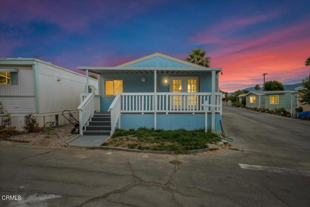 Modern three-bedroom, two-bath manufactured home situated in the scenic Ojai Valley. The property has been recently repainted and features updated flooring and an open floor plan. Kitchen amenities include a stainless steel refrigerator, stove, dishwasher, and microwave. The residence also offers an in-unit laundry area with shelving and pantry cabinetry, along with new patio railings and steps. Located within the Del Frasierra Park 55+ community, residents have access to a clubhouse, a pool table, a swimming pool, and additional amenities. This home is move-in ready.