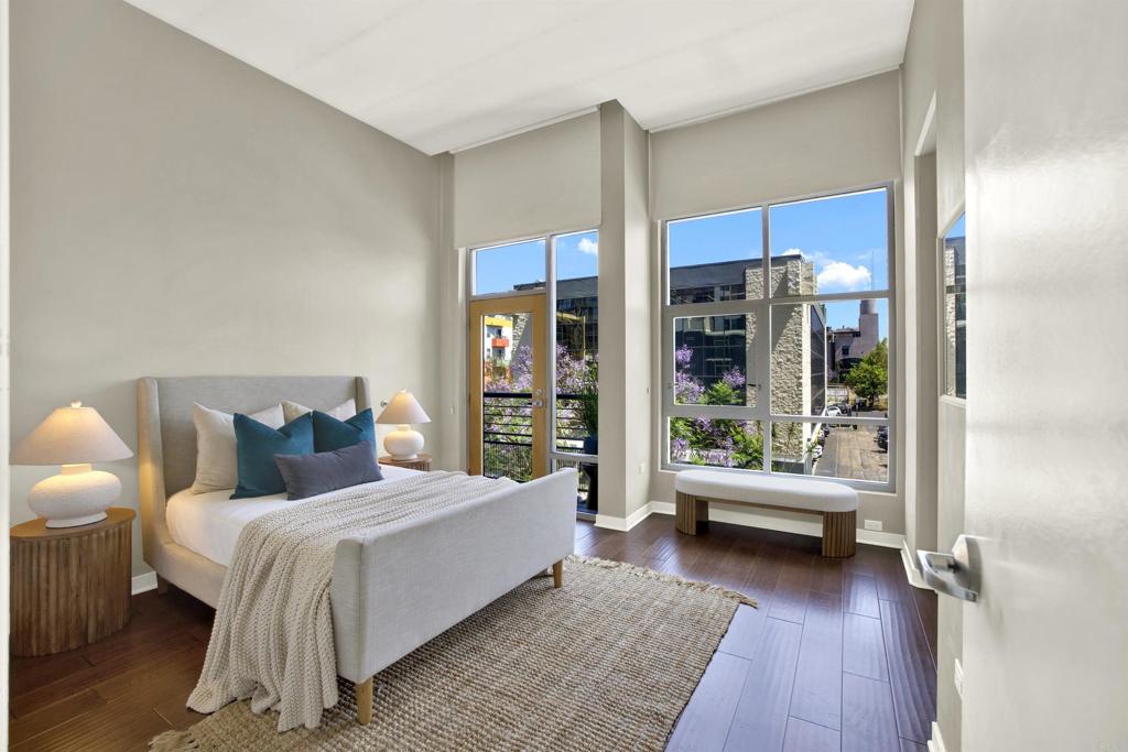 Welcome to Acqua Vista – where vibrant urban living meets modern comfort in the heart of Little Italy. This beautiful 2-bedroom, 2-bath condo offers 1,054 sq. ft. of single-level living in one of Downtown San Diego’s most sought-after neighborhoods. Located on the 4th floor of the desirable North Tower, this corner-unit-style home enjoys peaceful city views, added privacy, and abundant natural light thanks to its open exposure and thoughtful floor plan. Step inside to find newer flooring, high ceilings, two balconies, stainless steel appliances, in-unit laundry, and a dedicated dining space. The neutral color palette complements any design style, while the open layout offers the ideal balance of functionality and flow. Live steps from the Little Italy Farmers Market, renowned restaurants, craft coffee shops, boutique shopping, and the San Diego Bay. You’re a short walk from Portside Pier (9 mins), Seaport Village (20 mins), and the iconic Rady Shell (30 mins). Acqua Vista offers resort-style amenities, including 24/7 concierge, valet parking, a rooftop pool and spa, BBQ area, Amazon lockers, a well-equipped fitness center, and more. The condo includes one valet parking spot, and the option to lease an additional space through the HOA. Whether you're looking for a stylish primary residence, lock-and-leave second home, or a turnkey investment opportunity—this condo delivers unbeatable value, location, and lifestyle in San Diego’s most walkable and exciting neighborhood.
