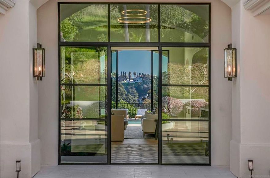 Sold before processing. Entered for comp purposes  Designed for owner-occupancy, it stands as a testament to exquisite craftsmanship & unparalleled comfort.  No expense spared, with a completely new roof , all new Marvin windows and Western door systems, a pass-through kitchen window and plenty of custom built-ins throughout, Luxuriate in the elegance of the herringbone laid, European white oak floors and custom hand-made tiles throughout. The heart of the home is a chef's dream kitchen, featuring a brand custom WIFI enabled Thermador appliances, including an 8-burner range w/ gas & induction cooktop along w/ steam,convection and warming ovens, dual dishwashers.  Glide effortlessly through custom glass entry door, the 11-ft sliders and multiple other sliding doors leading to the pool and yard. Entertain with flair in the brand-new pool and equipment, equipped with LED lighting and an automatic cover.  Outdoor space is complemented by all-new patio and hardscape features. Retreat to luxurious bathrooms complete w/ integrated sinks, custom brand-new fixtures throughout. Additionally, custom Lutron-controlled, automatic shades in every bedroom/bathroom. Other features include new tankless water heater,  plumbing, electrical, LED lighting, solar landscape lighting, and new epoxy garage flooring.