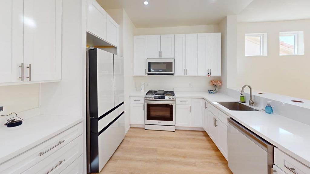 This gorgeous property has all your luxury and modern dreams in a 3 bedroom, 2.5 bath, and 1903 SqFt home in the sunny desert. This house has 13-foot-high cathedral ceilings, a spacious floor plan, plank vinyl wood-like flooring, and a marvelous mountain view. It is a brand-new home built in 2023. The home is enluminated with LED lights to create a bright environment, along with an abundance of windows to bring in natural lighting as well. The house showcases elegant doors, cabinets, and hardware to add to the uniqueness of this home. The boundless kitchen features new quartz counters, many cabinets to satisfy the special chef of the house, top-of-the-line Samsung bespoke appliances, an open breakfast bar, and an outlook into the living room. The dining room layout offers a great place to gather by featuring a sliding door to the private backyard, giving you the option to entertain your company inside or outside of your home. The main bedroom also has a sliding door for easy access to the private backyard. The main bathroom has a double sink with quartz countertops and a spacious shower with a glass door enclosure. All bedrooms have custom-made window coverings for privacy. The indoor Laundry room is located by the kitchen. The garage has additional cabinets with a counter area for special projects, and it has direct access to the home. The backyard is surrounded by a block wall to ensure privacy for any outdoor leisure activities. This home is equipped with a tankless water heater and a central air. This home is located near commercial centers, including supermarkets, restaurants, etc, along with a public park and the I-10 freeway. This home is built and designed to the satisfaction of the owner. Come see this magnificent house that could be yours!