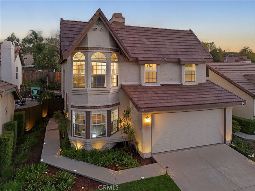 This is a rare find! One of the largest model homes in the highly sought after American Beauty Classics neighborhood - could be yours! Inside this fully modernized home is a neutral canvas ready for a new home owner's imagination. The moment you step through the front door you’ll notice how the natural lighting comes with you through the 2 story window panes making the entire house warm and bright. There are many open and inviting areas in this 2,349 square foot home to turn into creative spaces such as an exercise room, art & hobby room, kids playroom, and family living room. The open concept kitchen and dining room is updated and spacious making it a breeze to host family gatherings. The fireplace adds warmth and ambiance to family meals. As you walk through the french doors to the private backyard you’ll notice the brand new cedar fence beyond the large yard and patio. The backyard space is ready to be transformed into your own private oasis while the front yard is conveniently maintained by the HOA. Up the curved staircase you will find a loft area providing a cozy nook and gives the birds eye view from the top floor. To the left, the master suite has its own wing with a vaulted ceiling that gives off regal vibes. The master has a large lounge area that can also be turned into a library or powder room and an en-suite beautifully updated master bathroom with an adjoining walk-in closet. On the far side of the loft are the additional 3 spacious bedrooms and hall accessible full bathroom. There have been many updates and renovations including paid off Solar, brand new roof, new luxury vinyl flooring, new HVAC, new fans and fixtures, bathroom renovation, and reverse osmosis system. This home has no Mello Roos and very low HOA. You can’t get more safe and family friendly than this neighborhood complete with 4 pools, sport courts, park, a tot lot, and 24hr security