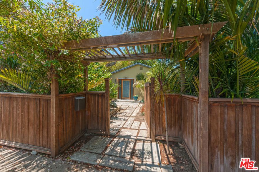 Enchanting organic modern artist's retreat in the coveted "Woods" neighborhood of Mar Vista. This creative mini-compound includes an upgraded 3 bed/2 bath front house plus a detached studio/studio/office/4th bedroom with bath.  Available fully furnished, this property features a delightful open plan front house with spacious living, dining & kitchen space with polished concrete floors and vaulted ceilings w/vintage beams reclaimed from the old Ocean Park pier.  Cook's kitchen w/sleek concrete countertops, breakfast bar, Wolf & Bosch appliances. Inviting dining area surrounded by lush garden windows.  Honey bamboo floors in master & 2 addtl bedrooms. Generous master suite overlooking the garden w/spa tub, skylight & walk in closet.  Artistic light fixtures & master bath glass sink, creative details throughout. French doors from master to enchanting entertainer's backyard w/outdoor Moroccan Room/lanai, hot tub, fire pit & peaceful sitting areas. Fabulous bonus guest studio/office/w/bath, high ceilings, skylight. Mature citrus & fruit trees, palms & a canopy of green creates a private oasis just over the Venice border in this desirable pocket of Mar Vista. Perfect for families, artists & soulful types who appreciate organic architecture, design & lush living near the beach. Electric car charger too! Move in ready fully furnished or negotiable.  Avail Feb 1st.