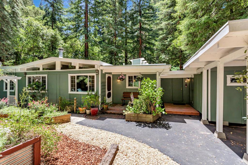 This eye-catching mid-century gem showcases timeless design and a cool retro vibe, featuring exposed beam ceilings, clerestory windows, and light-reflecting oak parquet flooring. A cozy wood stove adds warmth and ambience to the spacious living room, which is accented by a large book/display case. The oak and blue tile kitchen/dining area provides ample storage and counter space for all your culinary endeavors. The vintage charm continues in the Jack and Jill bath, where glass block and blue tile accents add a nostalgic touch. Master bedroom's patio doors lead to a spa overlooking the river that invites you to relax and unwind. Additional spaces include a craft room/office, a workshop/man cave, and two storage buildings. The onsite waste water septic system ensures long-term peace of mind. You'll love the convenient close in location North of town that jump starts your commute to the Silicon Valley and beyond.