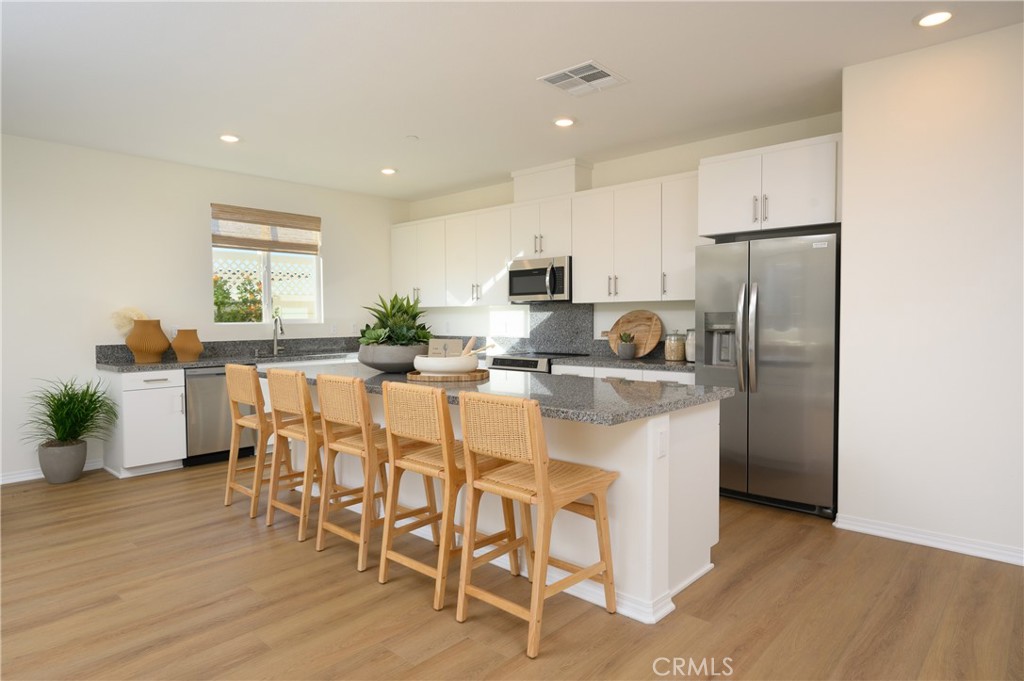NEW CONSTRUCTION! A new-single level home with a modern and low-maintenance layout. A spacious and flexible open-concept layout combines the kitchen, living and dining areas for effortless multitasking and entertaining. Three secondary bedrooms share a private hallway off the main living space, and the luxe owner’s suite is tucked into a private rear corner, serving as a serene retreat complete with a spa-inspired bathroom and roomy walk-in closet.
Silverstone is a brand-new collection bringing new single-family homes to the Green Valley Ranch masterplan, now selling in Perris, CA. Residents will enjoy access to fantastic onsite amenities and spacious, two-story home designs. Local attractions including Lake Perris, the Railway Museum and the Perris Speedway offer ample recreation and entertainment options. Proximity to the 215 and 74 freeways helps to simplify everyday commutes and travel, and the community is serviced by schools in the Romoland and Perris Unified School Districts.