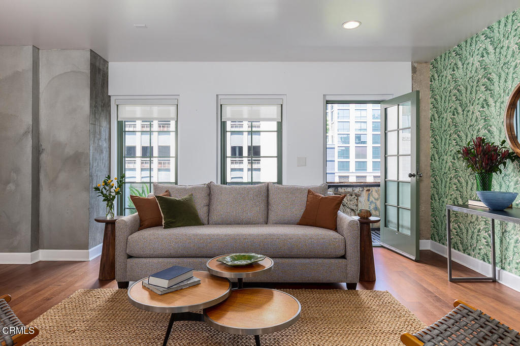Located in Downtown's Historic Core, this spacious unit in the El Dorado Lofts building is as captivating inside as it is from the exterior. Adjacent to many attractions beloved by downtown locals, this stunning Art Nouveau/Gothic Revival building is a protected Historic Cultural Landmark, with its facade decorated in a series of botanical motif friezes and verdigris-hue enameled brick. Architectural character features define interior common spaces as well, from the lobby lined in Bachelder tiles, to the handsome original wood front door of unit 505 with privacy glass and gold stencil work detail. Inside, the unit boasts desirable architectural details (exposed beams, steel sash windows, salvaged wood doors) as well as the practical features and amenities for modern day living (in-unit laundry, modern kitchen and bathrooms, multiple mini-split AC units). The home's tranquil primary suite with its own full bathroom and large walk-in closet provide ample storage. Entertainers will enjoy the ergonomically-designed kitchen, which opens to the spacious living area and dining room, lined with built-in bookshelves. A wall of west-facing windows offering ample natural light and opens onto a sunny private balcony with vibrant city views. Finally, a large office alcove with its own wall of built-ins offers flexibility - it's large enough to be a second bedroom (plans for converting the office to a second bedroom are already drawn) - and the second full bath is conveniently close. Buyers will benefit from the building's Mills Act status, resulting in the unit's significantly reduced property taxes - what a win! With proximity to the Downtown Farmers Market, Spring Street Dog Park, Grand Central Market, Los Angeles Athletic Club, and so many other great neighborhood spots, this home is truly a standout opportunity. This is an ideal home offering convenience and lifestyle in a beautiful envelope in the heart of the City.