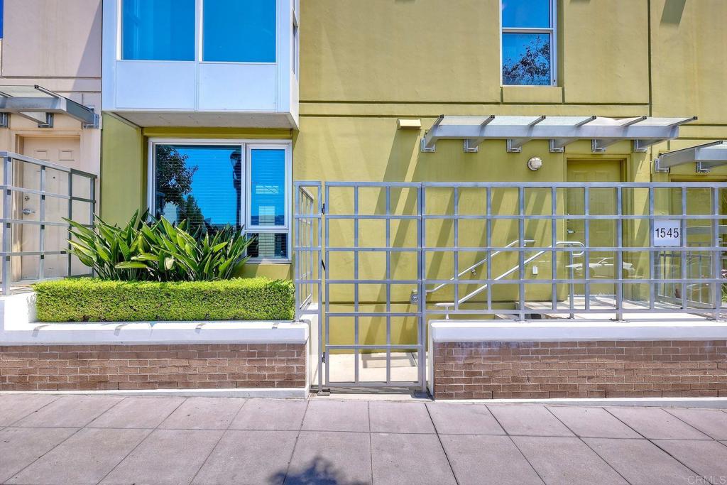 Discover rare three-level living at La Vita in San Diego’s coveted Little Italy. This 1,773 sq ft townhome blends modern comfort with resort-style amenities, just steps from the neighborhood’s acclaimed dining and scenic waterfront. A true downtown rarity, it offers an attached two-car garage with private stairwell access and dedicated storage—eliminating the parking challenges of city living. Multiple entry options add convenience, including direct access from State Street, entry through the interior courtyard with immediate connection to community amenities, or via the garage. The first floor features striking mosaic shell accent walls and open living and dining areas finished in bamboo hardwood flooring, with carpeting in the bedrooms and third-floor bonus room. The kitchen flows easily for entertaining, while upstairs, the second floor hosts two bedrooms, each with its own full bath, including a primary suite with ensuite bath. A laundry closet with stackable washer and dryer is also located on this level. The third floor offers a versatile bonus room that opens to a private terrace—perfect for use as an extra bedroom, office, gym, or creative space—along with a separate private balcony for quiet outdoor enjoyment. La Vita’s pet-friendly community features resort-style amenities including a pool, jacuzzi, fitness center, and beautifully landscaped courtyard. From your front door, explore Little Italy’s vibrant restaurants, markets, galleries, and waterfront paths, all while enjoying the rare combination of private multi-level living and downtown convenience.