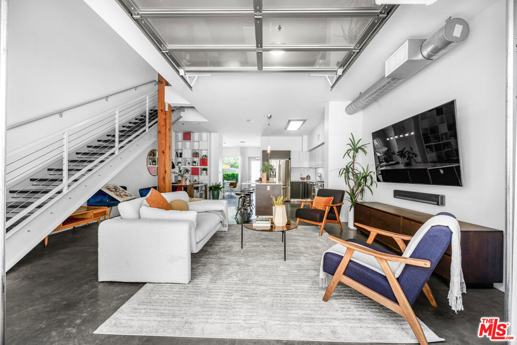 City living at its most striking, this industrial-style 2 bedroom/3 bath condominium on the Westside is tailor made for an urban professional looking for a sophisticated space to call home. Built in 2009, the modern architecture allows for exposed ductwork, beams and posts in this two-story home. Polished concrete floors, soaringly high ceilings, clean lines and minimal ornamentation makes for a quiet and calm canvas to let the added decor and art shine. Muted tones in the kitchen and aesthetically pleasing, you'll find high end stainless appliances, a beverage/wine fridge, large Caesar stone island and smooth, custom cabinetry. There's a glass garage-door separation between the Living Room and outdoor patio that basks the entire space in natural light. Up the Open Staircase with metal and wire banister you'll find the bedrooms, each very generous in size with exceptional light and large, custom closets. Additional amenities of this 1,610 sq ft home include: gated entry, open building with beautiful landscaping, fitness center, spa, barbeque, two underground reserved parking spots with additional space for guests, electric car chargers and located in an ideal area tucked between Brentwood/Santa Monica, convenient access to the Expo line and near the shops, businesses and restaurants of Sawtelle, Olympic and Pico. Tour this impressive property today!