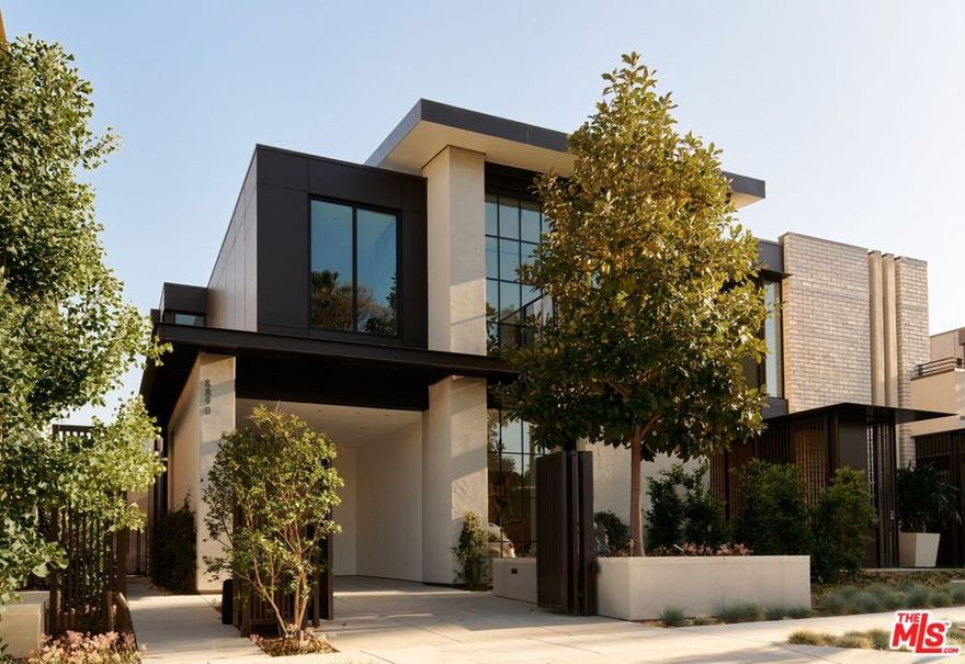 Glass House at 8899 Beverly. West Hollywood luxury presides at 8890 Rosewood Avenue where incredible resort amenities meet architectural brilliance. This exceptional home is part of a unique collection of eight signature homes crafted by the world-renowned architect Olson Kundig, each boasting a distinctive material palette and a one-of-a-kind living experience. Glass House is a stunning home with unparalleled features that epitomize comfort and understated opulence. This three-bedroom, two-level masterpiece immediately makes an impression with a modern exterior featuring exposed structural steel and a curved standing-seam metal roof, complemented by a painted metal trellis wrapping from the front to the side entry. True to its name, Glass House makes use of extensive glazing, soaring ceiling heights, and a natural flow between the indoor and outdoor environments to create open, airy living spaces. Sophisticated yet welcoming in design, the interior boasts wood floors, Lutron HomeWorks QS System lighting, and Fleetwood glazed doors and windows. The gourmet kitchen features top-of-the-line Gaggenau and Miele appliances, dark-stained white oak cabinetry, and custom paneling. A custom stairwell with open-riser wood treads and exposed steel curates an artful transition from level to level.Upstairs, the primary suite includes a private balcony adorned with a woven-wire mesh guardrail and steel grate decking, providing a tranquil retreat to unwind and admire the views. The ensuite bathroom has full stone flooring and walls made of Danube marble. Outside, find a chaparral-inspired garden curated by Coen + Partners, a pool and spa, and a guest house. Explore the eclectic palette of crepe myrtle and cork oak trees, exuberant bougainvillea, sea lavender, and fairy crassula, creating a picturesque backdrop for outdoor gatherings. The signature collection deftly blends individuality and privacy with exceptional resort lifestyle amenities. 8899 Beverly Boulevard  - offers residents access to 24-hour concierge service, a state-of-the-art fitness center, and a lushly landscaped oasis with a resort-style pool, spa, a custom outdoor kitchen, and an on-site restaurant, Stella. Experience the epitome of luxury urban living in West Hollywood.