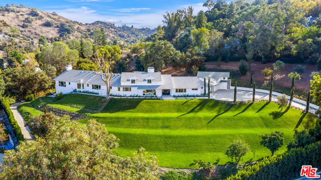 Located on a knoll within the desirable Longridge Estates, the Alomar Estate is situated on one of the largest lots in Sherman Oaks. The 2.3 acre compound w/ manicured gardens, rolling lawns, spectacular views, and attention to privacy offers an unparalleled park-like experience. Behind the gated entrance and tall hedges lays this single-story California Ranch estate, complete w/ a long private driveway. Highlights include a beautiful living rm, fabulously designed kitchen, and a separate guest rm. 6 bdrms are surrounded w/ picturesque views and the finest attention to detail. The master suite is 2nd to none w/ dual bathrooms, walk-in closets, and a sitting area w/ gorgeous views. Outside, the sprawling grounds host a swimming pool w/ cabana, nature trail throughout the estate and a white-sand beach - perfect for a game of volleyball or to sit around the firepit. Overlooking tranquil San Fernando Valley vistas, this stunning compound offers the utmost in elegance, style and security.