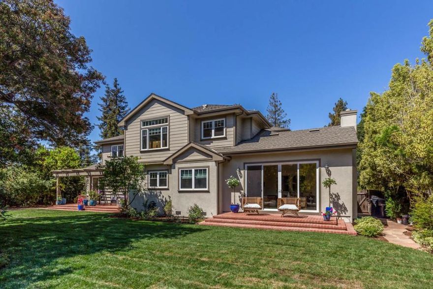 Located just steps to downtown, this spacious home features timeless design, a functional floor plan, and stunning park-like grounds. At the back of the home, the tremendous family room and gourmet kitchen overlook and have access to the verdant grounds and offer the ultimate venue for entertaining and enjoying with family. The formal dining room opens out to the yard, and has convenient access to the kitchen. On the main level youll find a light-filled bedroom suite and a quiet executive office, while the second level presents the expansive primary suite, an additional bedroom suite, and two well-sized bedrooms. The landscaped backyard offers numerous outdoor living spaces including a stone patio with a central water feature and playground, an extensive pergola covered patio ideal for dining al fresco, a second flagstone patio bordered by tall privacy hedges, and a vast stretch of lush lawn. A home that meets every need, walking distance to shops, restaurants, and top-rated schools.