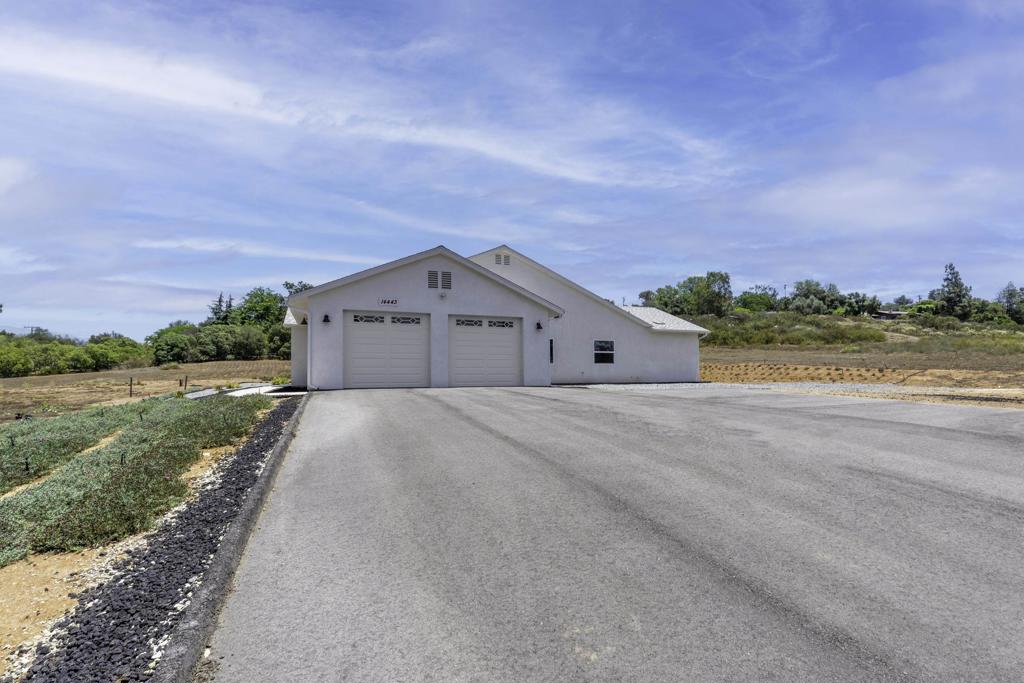 Stunning 2024 Custom-Built Home on 4.52 Acres with Solar + ADU Potential! Welcome to this beautifully designed 5-bedroom, 3-bath home. Offering 2,980 sq ft of living space and an attached 1,100 sq ft oversized 4-car garage—perfect for a workshop, storage, or both—this home blends comfort, utility, and expansion potential. Enjoy 9-foot ceilings throughout, a spacious open-concept layout, and a large kitchen with a generous prep island, breakfast counter, and a cozy coffee nook complete with wood surround and floating shelves. The luxurious master suite features a freestanding soaking tub, oversized shower, and an extra-large walk-in closet. Two of the bathrooms include dual sinks for added convenience. A dedicated laundry/mudroom with sink, cabinets, and counters connects directly to the garage for functional everyday living. The 4.52-acre lot includes a flat pad above the home—ideal for building one or more ADUs, a stable, or corral. Potential rental income could even cover your mortgage! The front yard is equipped with 3 standpipe hose bibs, offering water access for a future vineyard, garden, or animal setup. Built to current 2024 codes, the home features an OWNED SOLAR system with battery backup. Six critical circuits—including the kitchen—stay powered in an outage, and the system is easily expandable for even greater energy independence. This property is the perfect blend of rural flexibility and modern convenience—don’t miss it!