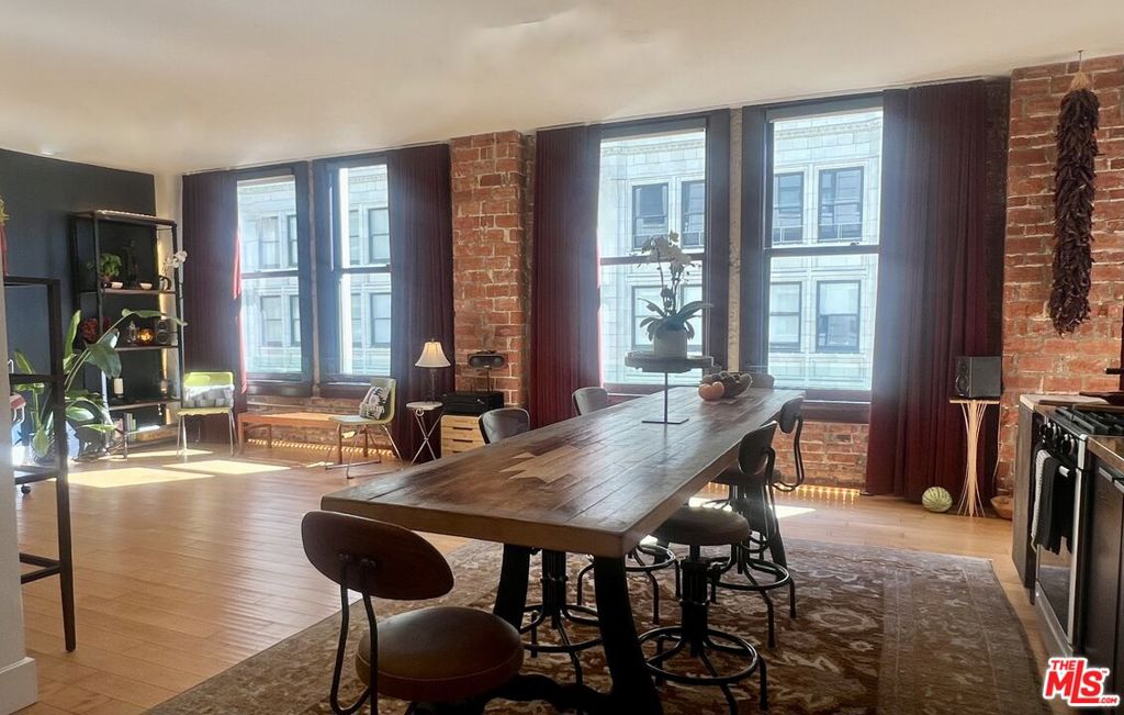 High style and cool vibes come together in this bright, incredible DTLA loft in the iconic Rowan Building. This flowing, spacious 8th floor loft with skyline views of the Historic Core features dramatic high-ceilings, gorgeous hardwood floors, 6 huge windows, and exposed brick walls. Phillips Hue lighting lets you set the mood, while custom-made floor-to-ceiling blackout velvet curtains give you ultimate privacy. This RARE 2-bedoom, 2-bathroom unit is currently configured as a grand 1-bedroom with an ensuite bathroom, with the second bathroom off the oversized living room that can be easily converted to a second bedroom. The gourmet kitchen features quartz counters, stainless appliances and tons of storage. Central heat & A/C, and in-unit stacked washer/dryer. The building's MILLS ACT designation gives owners substantial yearly property tax savings up to 70%. Residents enjoy a beautifully restored lobby and hallways, 24-hour front desk and reception, controlled building and common-area access, a 2nd floor WIFI-enabled lounge, outdoor gardens, outdoor plunge pools, and BBQ grills. Grand Central Market, Spring Street Dog Park, Metro, Gallery Row, Little Tokyo and tons of live-music venues are all nearby. Parking available for rent.