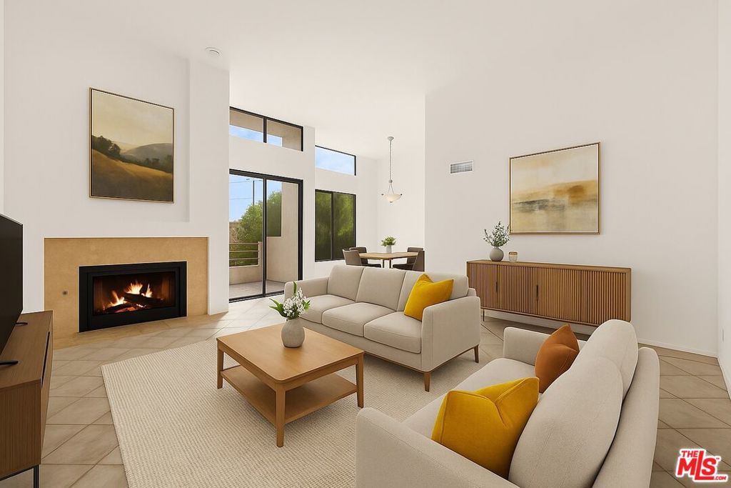 Discover the perfect blend of comfort, location, and opportunity in this top-floor West LA condo, just moments from Wilshire Blvd. This spacious two-bedroom, two-bath home offers high ceilings, floor-to-ceiling windows, and a large west-facing balcony that fills the living space with natural light. The layout flows seamlessly from the generous living room, complete with a cozy fireplace and wet bar, into the dedicated dining area and updated kitchen that comes equipped with all appliances - topped off with a wine fridge! The unit features a mix of elegant tile and updated LVP flooring, with carpeted bedrooms for added comfort. The primary suite includes a walk-in closet and en-suite bath, while the second bedroom is perfect for guests or a home office. A full second guest bathroom with step-in shower, in-unit laundry room with washer and dryer, and central HVAC add everyday convenience and comfort. Located in a safe and secure building with intercom access, and full gated garage - including 2 dedicated side-by-side parking spots for the unit. Move-in ready and full of potential, this condo is the perfect canvas to customize and make your own.