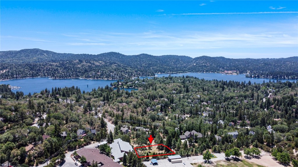 .56 ACRE. Amazing Vacant Lot! LAKE RIGHTS included! The adjacent lot is also for sale and shown in the pictures. Tucked away at the tranquil end of a quiet cul-de-sac lies a hidden gem. An untouched parcel gently sloping across a canvas of soft wild grasses. You can ensure relaxation on this serene mountain land. Peace is felt from hearing the soft rustle of leaves in the breeze. This haven offers a a perfect place to build a retreat, where the quiet hum of nature sings gently through open windows and time itself seems to slow. No passing thru traffic here. Just a 2 minute drive to Tavern Bay Beach Club. All utilities are available but not activated. Buyer is advised to do their due diligence.