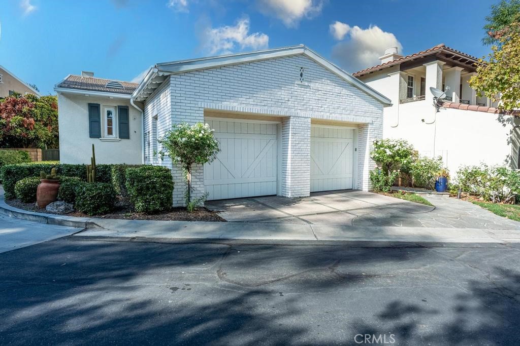 Welcome to The Woodlands, one of Valencia’s most sought-after 24 hour GUARD GATED communities. Finely manicured common areas, resplendent pool, spa and clubhouse, plus basketball and pickleball/tennis courts. This home is great for anyone who wants a primary bedroom on the first level, with two more bedrooms upstairs. With no single stories built in the Woodlands this floorplan is a popular choice for those that want a floorplan that lives like a single story. The primary suite features a large walk in closet, updated bath including quartz counters, upgraded tile, and a shower plus soaking tub. The other two bathrooms have been nicely updated as well, along with recessed lighting in the kitchen and living area, plantation shutters throughout, quartz kitchen island and sink, white cabinets and more. The backyard is nicely planted, with mature landscape, privacy and a patio/courtyard on the side of the home for outdoor relaxation. Come see this charming home while it is available!