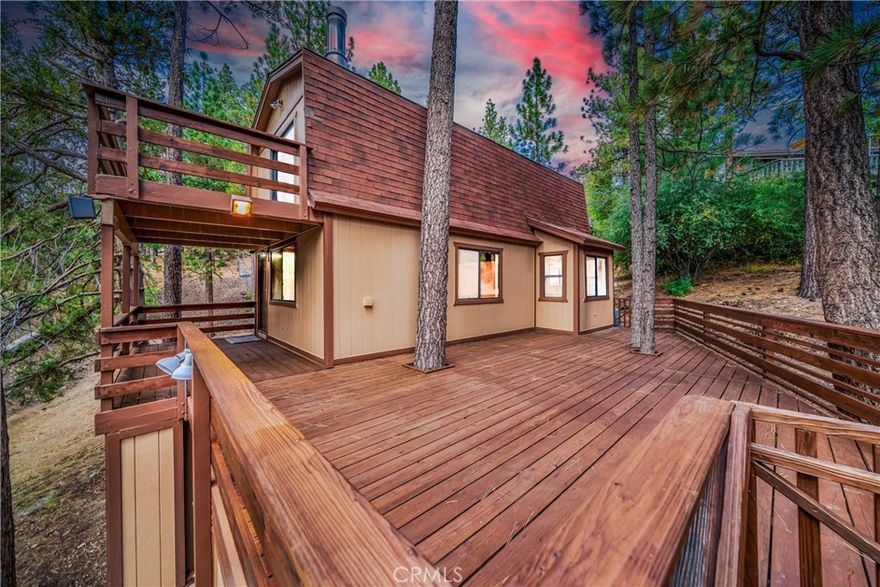 Welcome to your mountain escape in beautiful Big Bear Lake! This fully REMODELED 2-bedroom, 2-bath cabin perfectly blends modern updates with cozy alpine charm. Nestled on a 4,070 sqft lot, this home is move-in ready and brimming with features designed for comfort, adventure, and relaxation. Step inside to discover a bright, freshly painted interior with new vinyl flooring, plush carpet, and updated bathrooms. The kitchen is a showstopper, boasting sleek quartz countertops and stainless steel appliances—perfect for preparing meals after a day on the slopes. Enjoy the mountain air and BREATHTAKING VIEWS from your large wraparound deck, an ideal spot for morning coffee, evening sunsets, or entertaining friends and family year-round. But what truly sets this property apart is the oversized mudroom/storage basement equipped with a fridge, wine rack and electrical—a rare find in Big Bear! Big enough to house dirt bikes, skis, kayaks, snowboards, and more, it’s a dream for outdoor enthusiasts who want both convenience and adventure at their doorstep. LOCATION LOCATION LOCATION: you’re just a short drive to Snow Summit, Bear Mountain, Big Bear Lake, Big Bear Zoo, and The Village for shopping and dining. Plus, the home is within walking distance of the shuttle that takes you straight into town and up to the slopes—making it effortless to enjoy all that Big Bear has to offer. Whether you’re looking for a full-time residence, vacation getaway, or investment opportunity, this mountain retreat is ready to welcome you home. Don’t miss your chance to own a piece of Big Bear paradise!