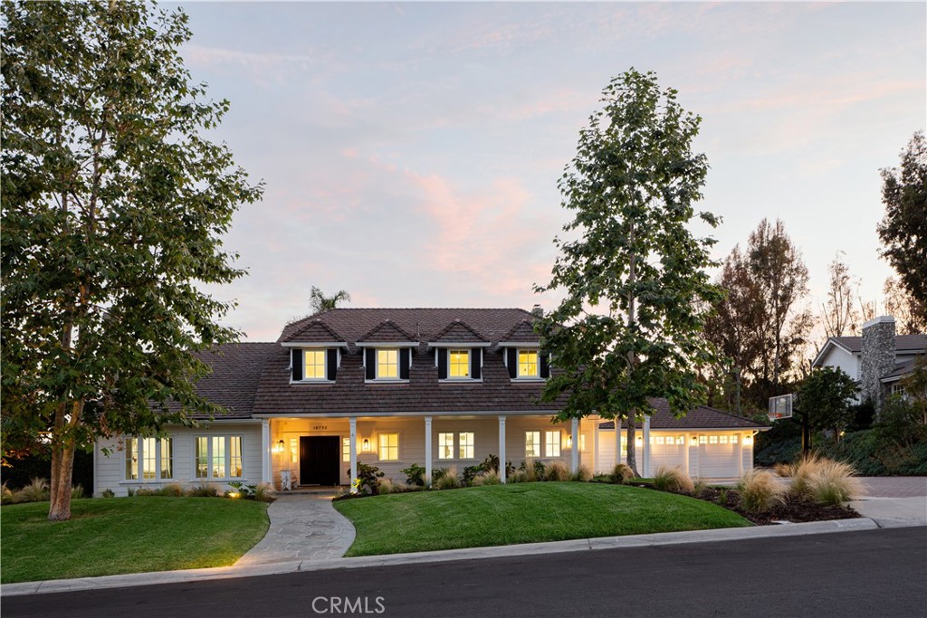 Welcome to 18732 Monte Vista Circle – a refined haven nestled on a quiet cul-de-sac in the sought-after hills of Villa Park. This thoughtfully designed 4-bedroom, 3.5 bathroom estate blends modern elegance with timeless character, all wrapped in a serene, private setting. From the moment you arrive, you’re greeted by a stately facade, manicured grounds, and curated details that hint at the sophistication within. Step inside to soaring ceilings, abundant natural light, and a spacious, open-concept layout that seamlessly connects living, dining, and entertaining spaces. At the heart of the home lies a stunning chef’s kitchen – outfitted with premium appliances, stone countertops, and 2 large islands ideal for serving, gathering and eating around. The kitchen flows effortlessly into a formal dining area and an expansive living room anchored by a statement fireplace. Tucked away on the main level, the luxurious primary suite feels like a five-star retreat – complete with French doors that open to the verdant backyard, cozy fireplace, spa-inspired bathroom with Victoria & Albert soaking tub, walk-in shower wrapped in hand-cut Carrera tile, and a custom-designed walk-in closet. Upstairs, find 3 additional bedrooms, two well-appointed bathrooms, a dedicated office and a generous bonus room perfect for movie nights, gaming, or creative pursuits. But the real magic unfolds outdoors. Designed for year-round enjoyment, the backyard is a showpiece of California living – featuring an oversized covered patio with outdoor dining and lounge areas, a sparkling heated pool and spa, built-in firepit, and lush, mature landscaping offering beauty and privacy. The dreamy setting makes entertaining effortless, while the elevated design invites moments of quiet relaxation under the stars. Additional highlights include a four-car tandem garage, additional half bath accessible poolside, Tesla charger, expansive mudroom and energy efficient solar panels. 18732 Monte Vista offers exceptional access to award-winning schools, local amenities, and the best of Orange County living. This is not just a home – it’s a lifestyle.