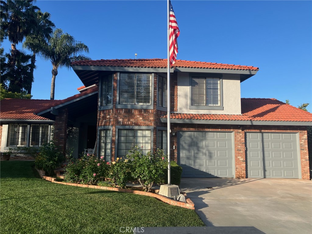 Beautiful home in a desirable area of Yucaipa, known as " the red tiled roof homes". The home has been remodeled over the years. Original owners have lovingly maintained this home which boasts 5 bedrooms, one downstairs, 4 upstairs, 2.5 baths, 2409 sq ft of comfortable living space on a generous 10,600 sq ft corner lot. The kitchen has been tastefully remodeled and features granite counters, spacious living room and a cozy family room with a heatilator fireplace. There are shutters throughout. The primary suite has a balcony and the bathroom has been remodeled with a walk in shower. A handy laundry chute is located in the upstairs 2nd bathroom straight down to the laundry room. The oversized indoor laundry room and a whole house fan add everyday convenience. Step outside to a private backyard oasis with mature landscaping, a sparkling pool, and included TV-perfect for entertaining or relaxing with friends and family. The attached garage has a convenient "drive thru" double door for easy access to the backyard for additional parking or projects. This home has a friendly layout and a must see in one of Yucaipa's most popular neighborhoods.