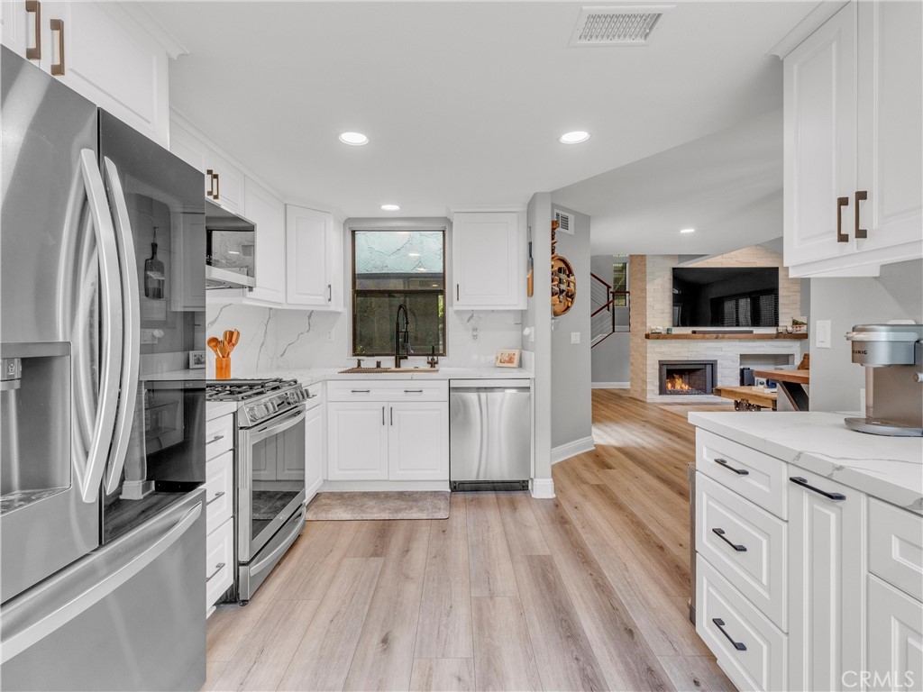 Step into a home where industrial edge meets modern elegance - welcome to your fully renovated, move-in-ready townhouse in the heart of Agoura Hills. This stunning 3-bedroom, 3-bath residence spans 1,629 square feet and features over $145,000 in upgrades completed in the last two years, offering a lifestyle that’s as stylish as it is effortless. Almost every inch of this home has been meticulously transformed. Brand-new flooring flows seamlessly throughout, complemented by a striking floor-to-ceiling stacked stone fireplace wall that anchors the open living space with dramatic flair. The kitchen is a chef’s dream - reimagined with sleek cabinetry, stainless appliances, and modern finishes that make both everyday meals and entertaining a delight. Each bathroom has been luxuriously updated, featuring designer touches for a spa-like experience.
Fresh paint and all-new light fixtures brighten every room, while custom barn doors add a touch of industrial character and privacy where you need it most. The upgraded electrical panel ensures peace of mind and supports all your modern living needs. Nestled in a sought-after Agoura Hills neighborhood, you’re just moments from top-rated schools, vibrant dining, boutique shopping, and convenient public transportation. Imagine morning strolls to nearby parks, afternoons exploring local cafes, and evenings unwinding in your beautifully curated home.