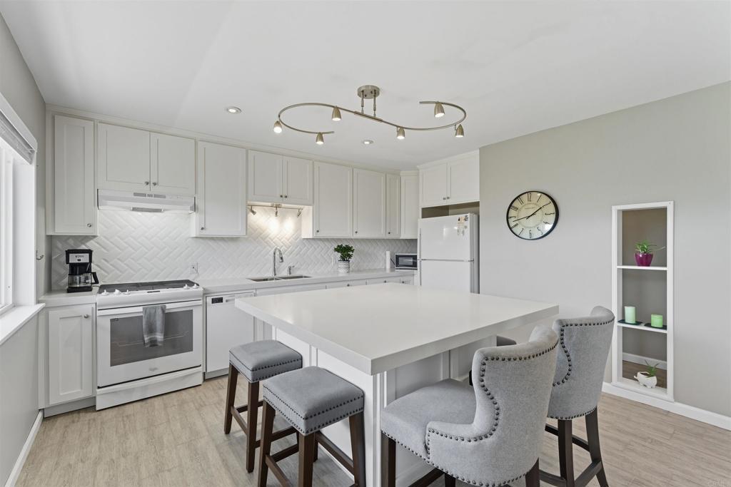 WOW!!! You have to see this one in person!! Beautifully remodeled top to bottom. Step into a space that seems like it's out of a magazine! Huge open concept kitchen/dining/living. New dual pane windows bring in amazing light, reflecting the beautifully maintained garden oasis courtyard. Melodic sound from water feature. New plumbing & electric.HUGE island with lots of storage, easily seats 6. Beautiful cabinetry with pull outs, quartz countertops, wood design tile flooring throughout, except bedrooms. Carpet is new. Mini splits in LR & Bedrooms, stackable washer/dryer in hall, brand new dishwasher. Abundant light, glass front door, security screen door. Sits at end of walkway offering total privacy. Gorgeous courtyard with sitting area, water feature and beautiful landscaping. 1 block off of El Cajon Blvd. Total North Park vibe without the traffic. HOA pays water/trash. Very quiet, fantastic neighborhood. Close to all you need walking or driving. Must see in person, photos do not reveal the charm and warmth of this unit or courtyard. Lowest HOA fees in North Park! Building has new electric panel box. Beautifully maintained building. Onsite laundry room as well.